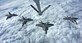 Four F-22 Raptors from the 27th Fighter Squadron out of Joint Base Langley-Eustis, Va., fly in formation below a 434th Air Refueling Wing KC-135R Stratotanker from Grissom Air Reserve Base, Ind., prior to a flyover in Tipton, Ind., Sept. 29, 2016.  The flyover was part of a memorial ceremony for Army Air Corps 1st Lt. Robert McIntosh, who passed away after his aircraft crashed during World War II. (U.S. Air Force Photo/Col. Hiram Gates)