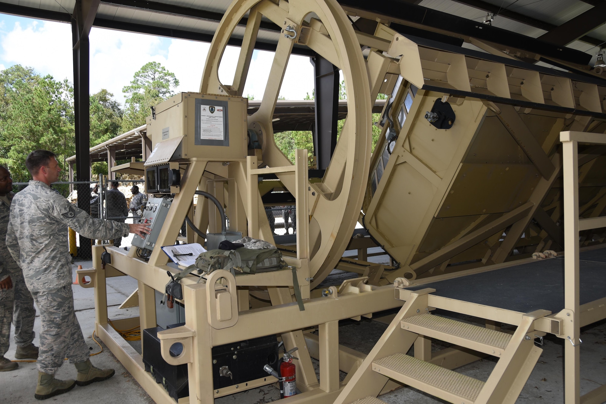 Staff Sgt. Kevin Weier, with the 820th Combat Operations
Squadron’s Innovative Combat Equipment, told the MRAP’s occupants what to expect during each roll. (U.S. Air Force photo by Ed Aspera)