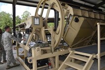 Staff Sgt. Kevin Weier, with the 820th Combat Operations
Squadron’s Innovative Combat Equipment, told the MRAP’s occupants what to expect during each roll. (U.S. Air Force photo by Ed Aspera)