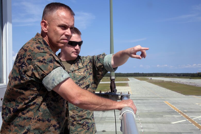 Brig. Gen. Matthew Glavy listens as Maj. Adam McArthur points at various operational parts of a runway during a visit aboard Marine Corps Auxiliary Landing Field Bogue, N.C., Sept. 28, 2016. Glavy visited the airfield to thank Marines for their hard work, to better understand the challenges they overcome on a daily basis and set eyes on supporting facilities to ensure they are maintained to high standards. “Bogue represents the 2nd Marine Aircraft Wing’s ability to conduct expeditionary operations,” said Glavy. “They provide aviation ground support, air traffic control, and operations support to the aircraft that rely on them. It is a unique place where 2nd MAW can get critical expeditionary training that we cannot receive anywhere else.” Glavy is the commanding general for 2nd MAW and McArthur is the Aviation Ranges Project Lead in 2nd MAW G3. (U.S. Marine Corps photo by Lance Cpl. Mackenzie Gibson/Released)