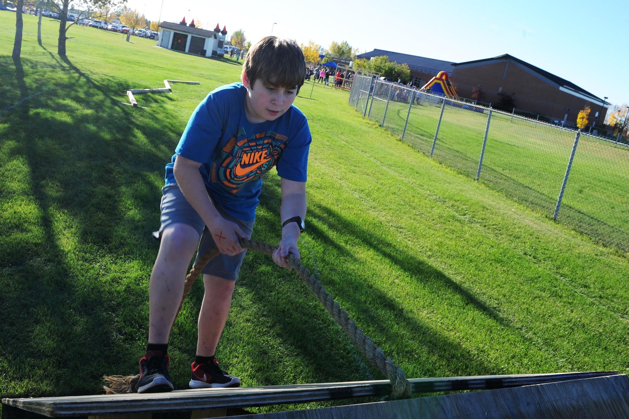 A military child climbs up an obstacle during the Ninja Warrior obstacle course at Minot Air Force Base, N.D., Sept. 26, 2016. The event had over 10 obstacles for the children and adults to go through. (U.S. Air Force photo/Senior Airman Kristoffer Kaubisch)