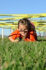 A military child crawls under an obstacle during the Ninja Warrior obstacle course at Minot Air Force Base, N.D., Sept. 26, 2016. The event was held in recognition of the Boys and Girls Club of America’s worldwide day of play. (U.S. Air Force photos/Senior Airman Kristoffer Kaubisch)
