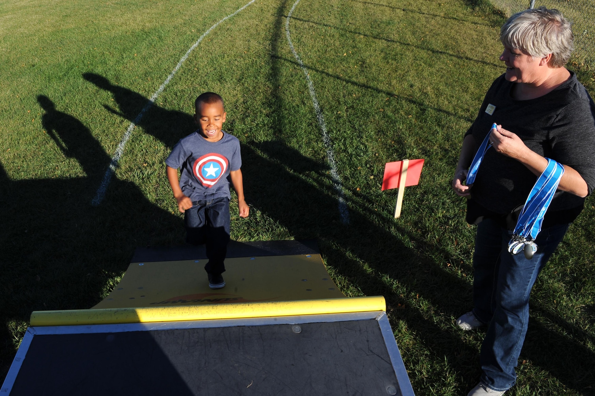 A military child runs up the final obstacle during the Ninja Warrior obstacle course at Minot Air Force Base, N.D., Sept. 26, 2016. Everyone received a medal once they finished the course. (U.S. Air Force photos/Senior Airman Kristoffer Kaubisch)