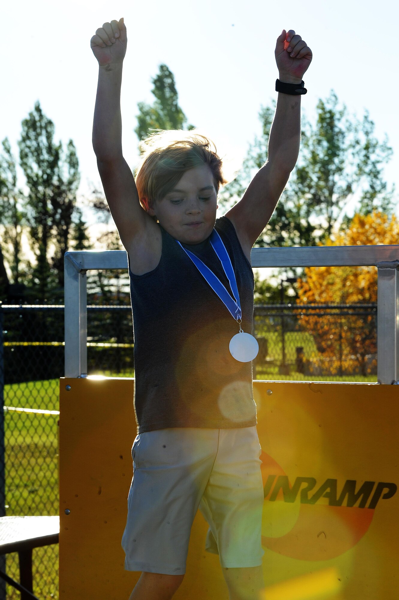A military child cheers as he finished the Ninja Warrior obstacle course at Minot Air Force Base, N.D., Sept. 26, 2016. The event had over 10 obstacles for the children and adults to go through. Everyone received a medal once they finished the course. (U.S. Air Force photos/Senior Airman Kristoffer Kaubisch)