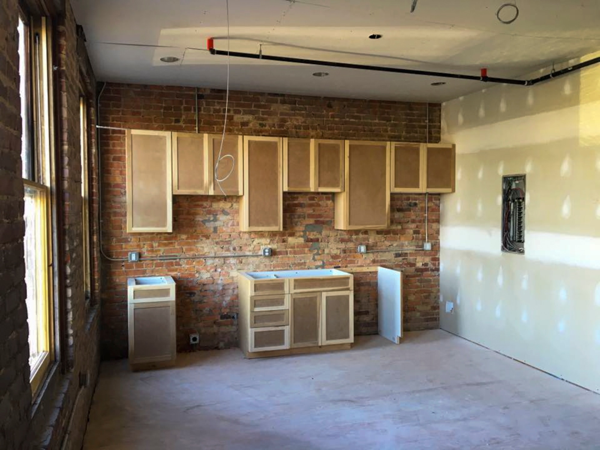 Kitchen cabinets are installed in one of five apartment spaces in the N. John Street properties, Aug. 23, 2016, in Downtown Goldsboro, North Carolina. Maj. Christopher Mohr, 77th Air Refueling Squadron operations officer, and his wife Bethany, began construction to turn the property into five 930-950 square foot apartments on the upper floor and the main floor into a 4,000 square foot brewery. (Courtesy photo)