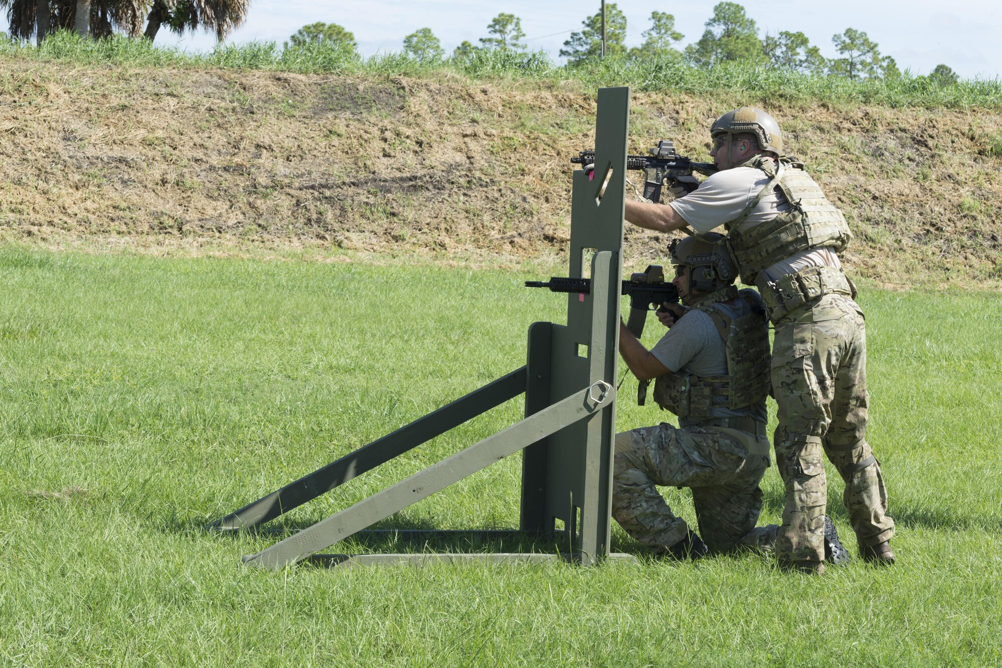 Two pararescumen, or PJs, set-up and take their positions to fire their weapons during the 2016 Pararescue Rodeo hosted by the 920th Rescue Wing, Patrick Air Force Base, Florida, September 20, 2016. The rodeo, also known as a skills competition, was a week-long event which tested PJs on skill sets such as precision-parachute jumping, rifle and pistol accuracy shooting, open-ocean surface swimming, high-angle and confined space rescues, water rescues and overall physical endurance. (U.S. Air Force photo/ 2nd Lt. Katie Spencer)