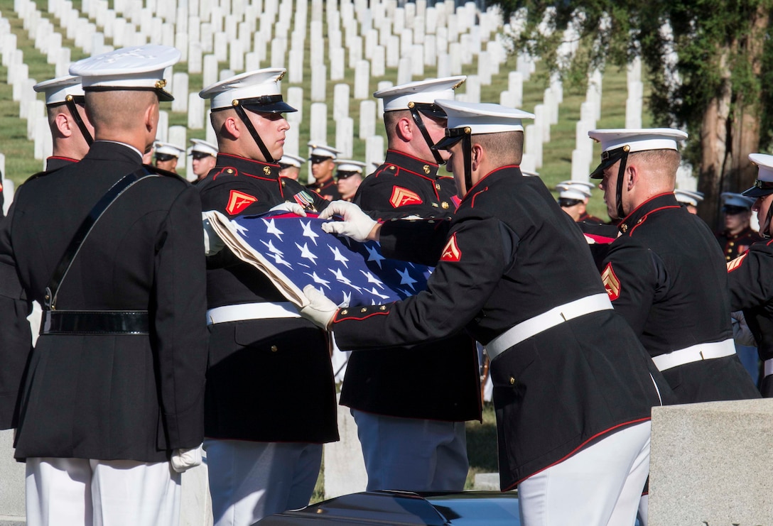 Body Bearers from Bravo Company , Marine Barracks Washington, D.C., conduct the flag folding ceremony during a full honors funeral at Arlington National Cemetery, Va., Sept. 23, 2016. Bravo Company is home to the Marine Corps Body Bearers, those Marines who carry the caskets for all Marine Corps funerals within the National Capitol Region and other set locations. (Official Marine Corps photo by Cpl. Andrianna Daly/Released)