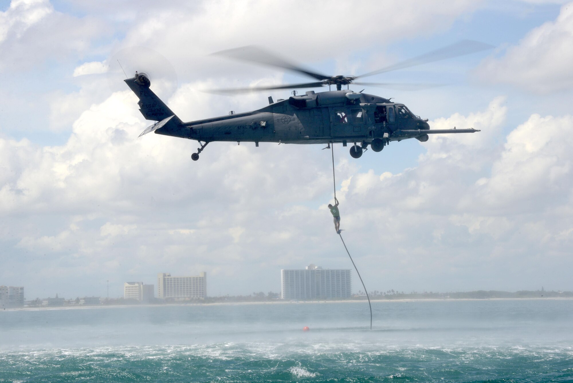 A pararescuman, or PJ, fast ropes from an HH-60G Pavehawk helicopter before swimming 1,500 meters to shore during the 2016 Pararescue Rodeo hosted by the 920th Rescue Wing, Patrick Air Force Base, Florida, September 21, 2016. The rodeo, also known as a skills competition, was a week-long event which tested PJs on skill sets such as precision-parachute jumping, rifle and pistol accuracy shooting, open-ocean surface swimming, high-angle and confined space rescues, water rescues and overall physical endurance. (U.S. Air Force photo/ 2nd Lt. Katie Spencer)