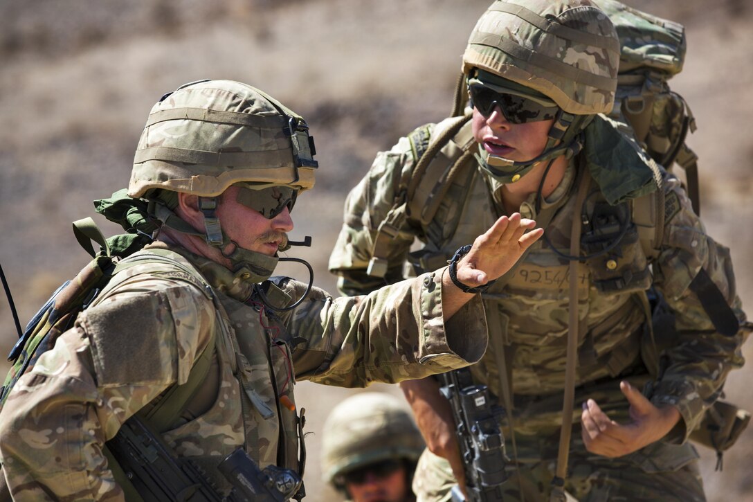 British Royal Marines discuss their scheme of maneuver during an assault on Range 205 as part of Exercise Black Alligator aboard the Marine Corps Air Ground Combat Center, Twentynine Palms, Calif., Sept. 13, 2016. U.S. and British Royal Marines conducted bilateral training in urban warfare maneuvers at Twentynine Palms, Calif. (U.S. Marine Corps photo by Cpl. Levi Schultz)