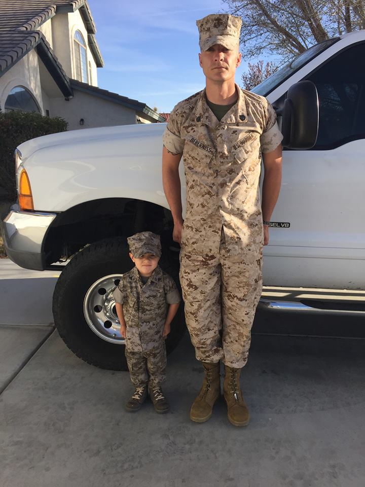 Staff Sergeant Nicholas Beberniss stands at attention with his 4-year-old son, Mason during a simulated promotion ceremony. Mason was "promoted" to Lance Corporal within the family and he proudly emmulates his father. 