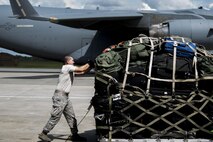 U.S. Air Force Staff Sgt. Brennon Scott, 23d Logistics Readiness Squadron air terminal operations supervisor, secures luggage and weapons on a pallet for a deployment, Sept. 26, 2016, at Moody Air Force Base, Ga. The pallet was loaded onto a C-17 Globemaster III for transport. (U.S. Air Force photo by Airman 1st Class Daniel Snider)
