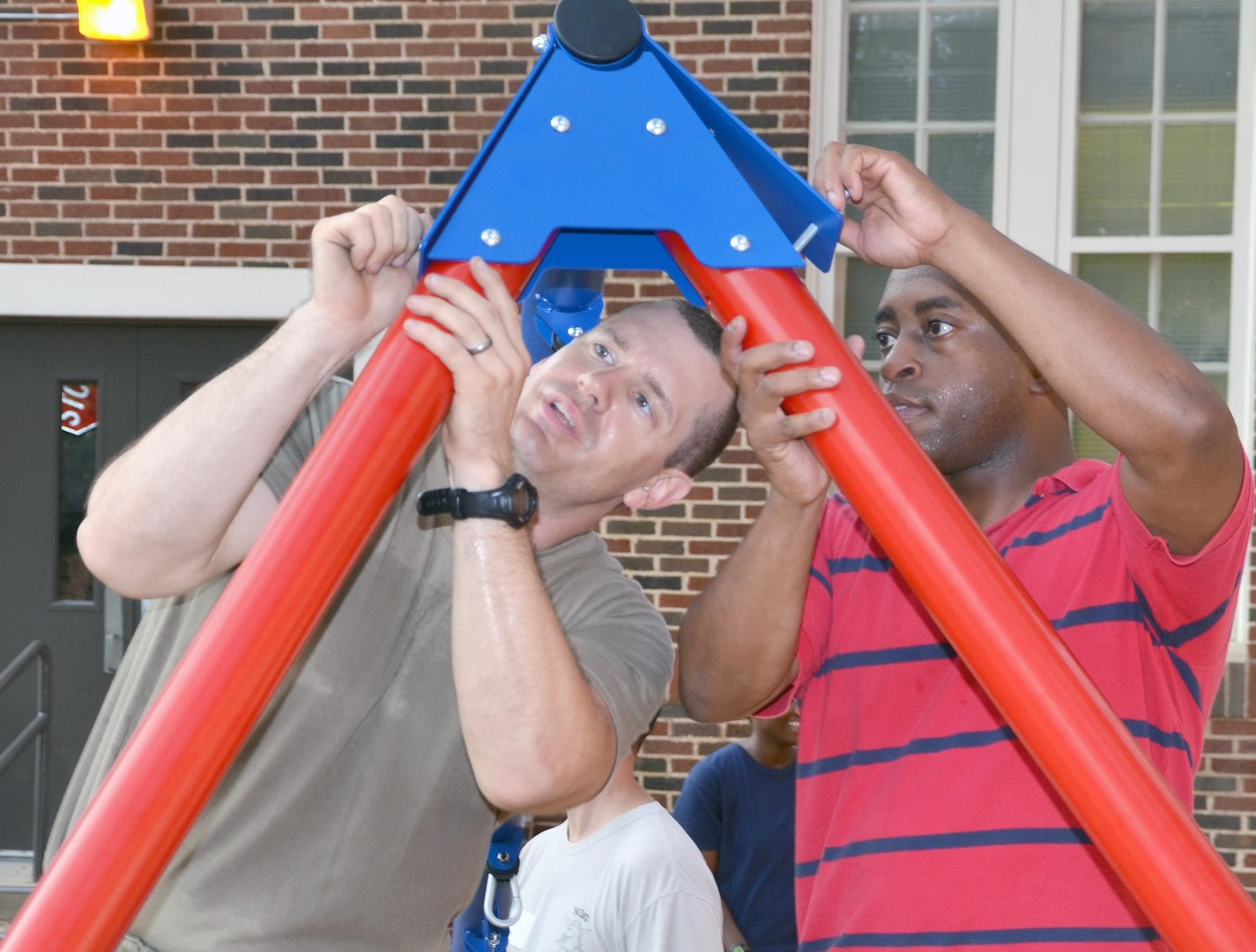 Sgt. 1st Class Joseph Williams (left) and Sgt. 1st Class Kevin Carter (right) assemble a swing set at Lamar Elementary School Sept. 23 in San Antonio. Soldiers from the 412th Contracting Support Brigade at Joint Base San Antonio-Fort Sam Houston volunteered their time at the elementary assembling two swings and building garden beds for the elementary as part of an adopt-a-school initiative between Army organizations at JBSA-Fort Sam Houston and local schools.  