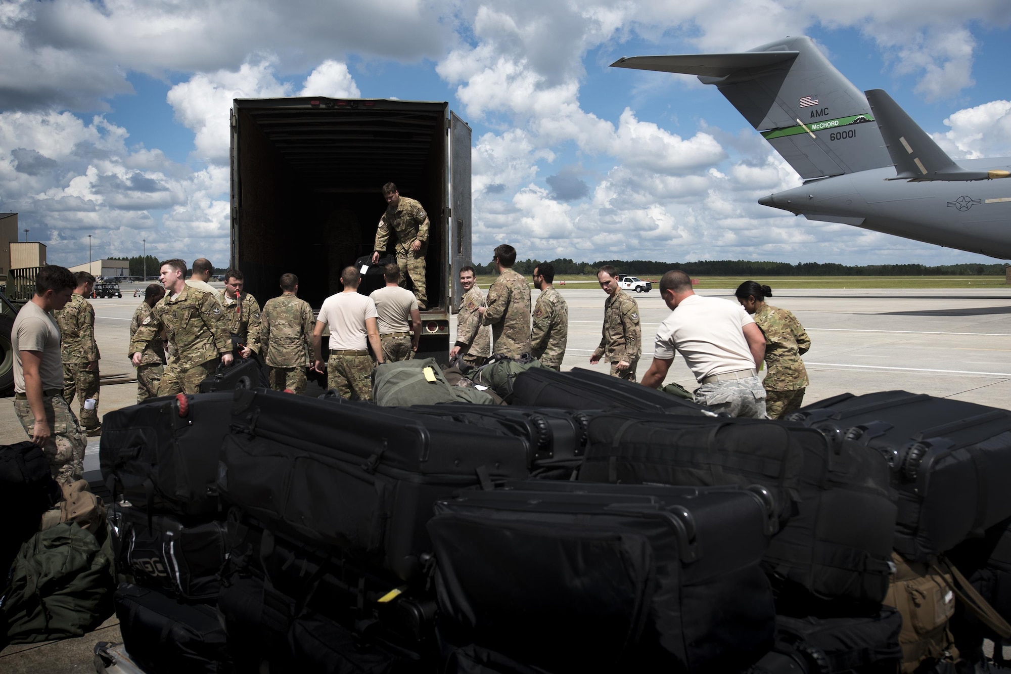 U.S. Air Force Airmen assigned to the 38th and 41st Rescue Squadrons unload their luggage from a semitrailer, Sept. 26, 2016, at Moody Air Force Base, Ga. Airmen worked together to stack luggage and weapons onto pallets to accompany them on a deployment to Southeast Europe. (U.S. Air Force photo by Airman 1st Class Daniel Snider)