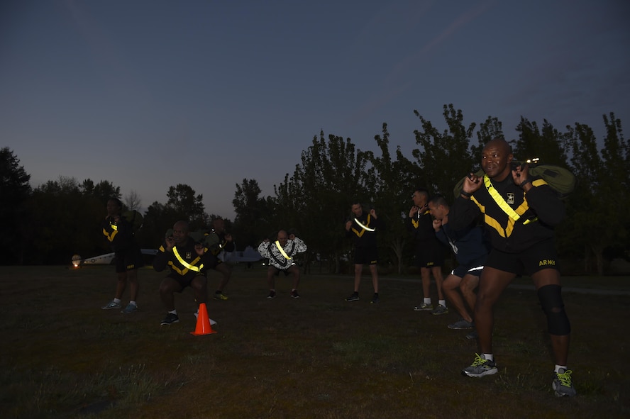 Air Force and Army senior enlisted members do air squats Sept. 29, 2016 at Heritage Hill on Joint Base Lewis-McChord, Wash. The senior enlisted members at JBLM were using the joint physical training session as a team building exercise. (U.S. Air Force photo/Staff Sgt. Naomi Shipley)