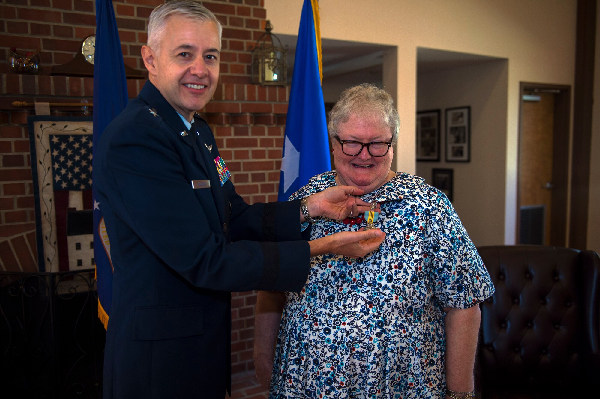 U.S. Air Force Retired Brigadier General Kenneth Todorov, former 23d Wing commander, places a Meritorious Civilian Service Medal on Ann Lukens, 23d Force Support Squadron school liaison officer, during her retirement ceremony, Sept. 30, 2016, at Moody Air Force, Ga. Lukens served as the bases’ first and only school liaison officer, advocating for the educational needs of approximately 1400 children of Team Moody personnel. (U.S. Air Force photo by Airman 1st Class Greg Nash)