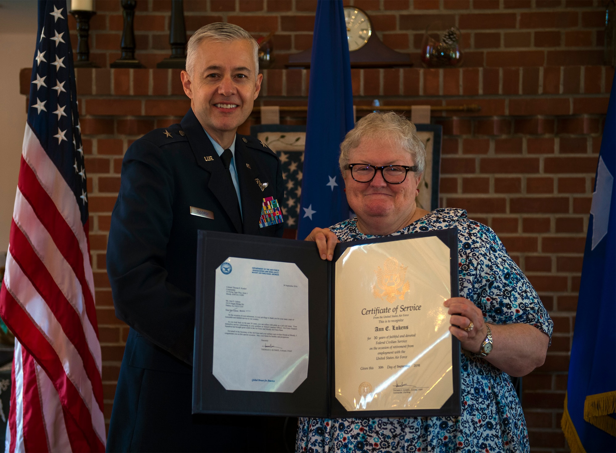 U.S. Air Force Retired Brigadier General Kenneth Todorov, former 23d Wing commander, presents a retirement certificate to Ann Lukens, 23d Force Support Squadron school liaison officer, during her retirement ceremony, Sept. 30, 2016, at Moody Air Force Base, Ga. Prior to her school liaison officer duties, Lukens served as the Airman & Family Readiness director at Moody from 1989 to 2008. (U.S. Air Force photo by Airman 1st Class Greg Nash)