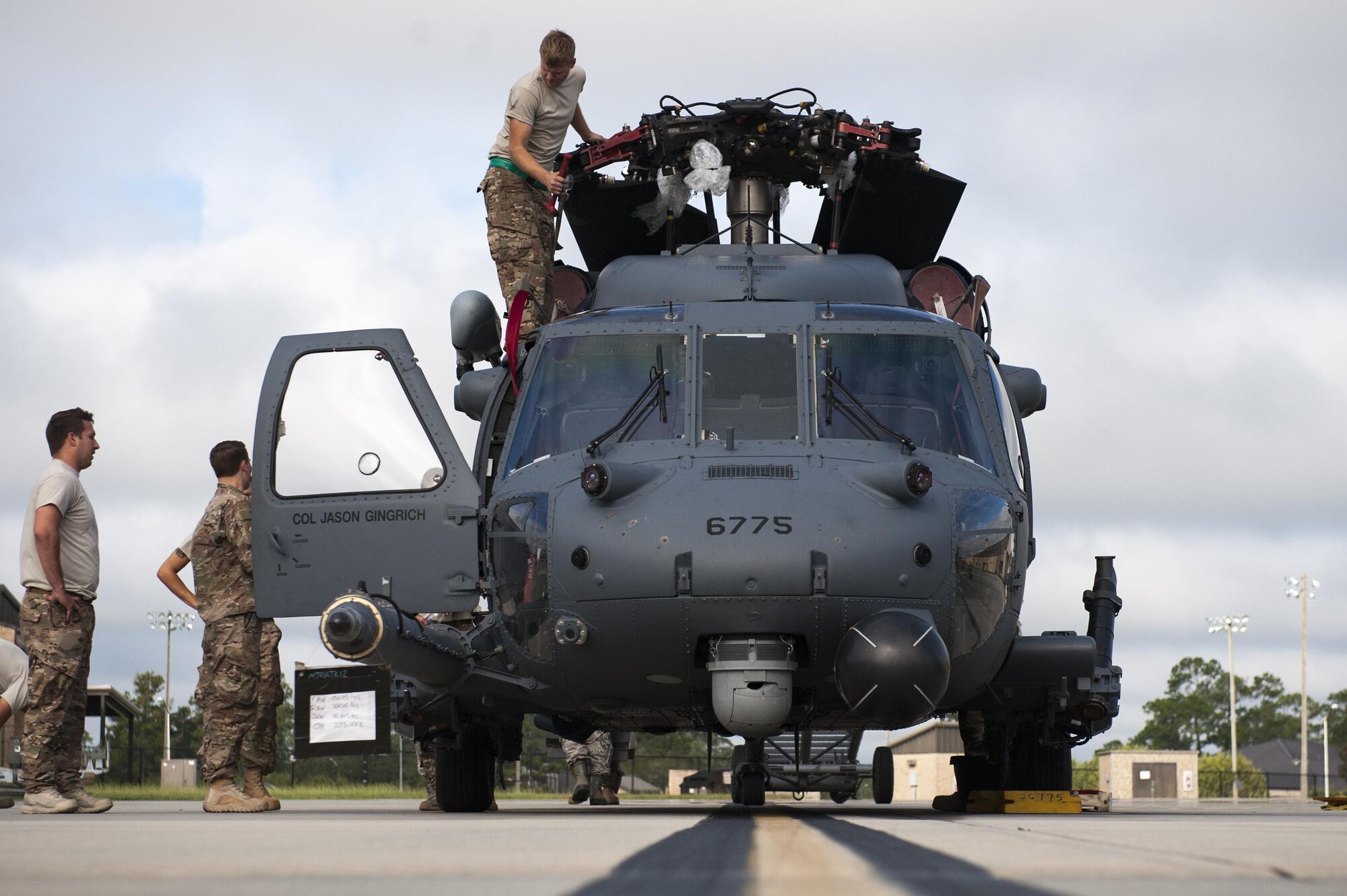 U.S. Air Force Airmen assigned to the 41st Helicopter Maintenance Unit finish folding the blades attached to an HH-60G Pave hawk during rapid rescue preparation before the helicopter deployed, Sept. 13, 2016, at Moody Air Force Base, Ga. This helicopter was deployed to Southeast Europe in support of recue missions. (U.S. Air Force photo by Airman 1st Class Daniel Snider)