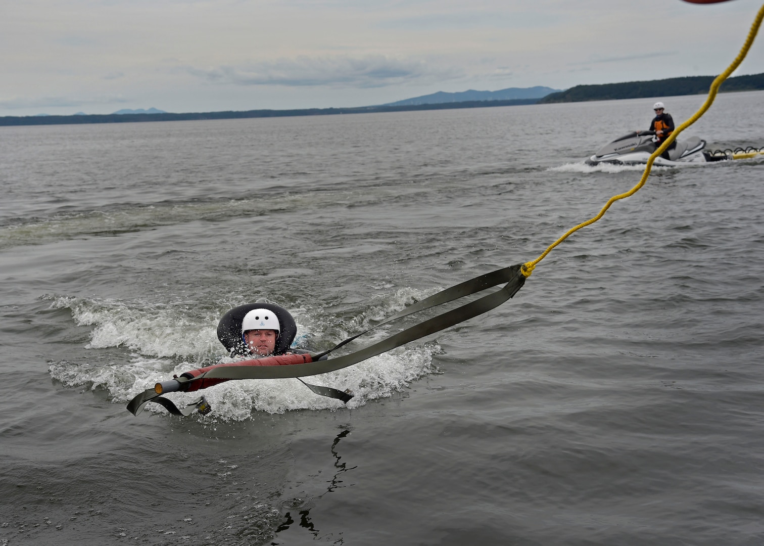 U.S. Air Force Lt. Col. Westly Hales, incoming 35th Fighter Wing chief of advanced programs, demonstrates a parachute drag across Lake Ogawara at Misawa Air Base, Japan, Sept. 20, 2016. Survival, Evasion, Resistance, and Escape specialists teach pilots how to properly and safely release themselves from a parachute being drug by the wind. Undergoing this training every three years is critical to the pilots because it may be the only time they are able to demonstrate these techniques before an emergency situation. 