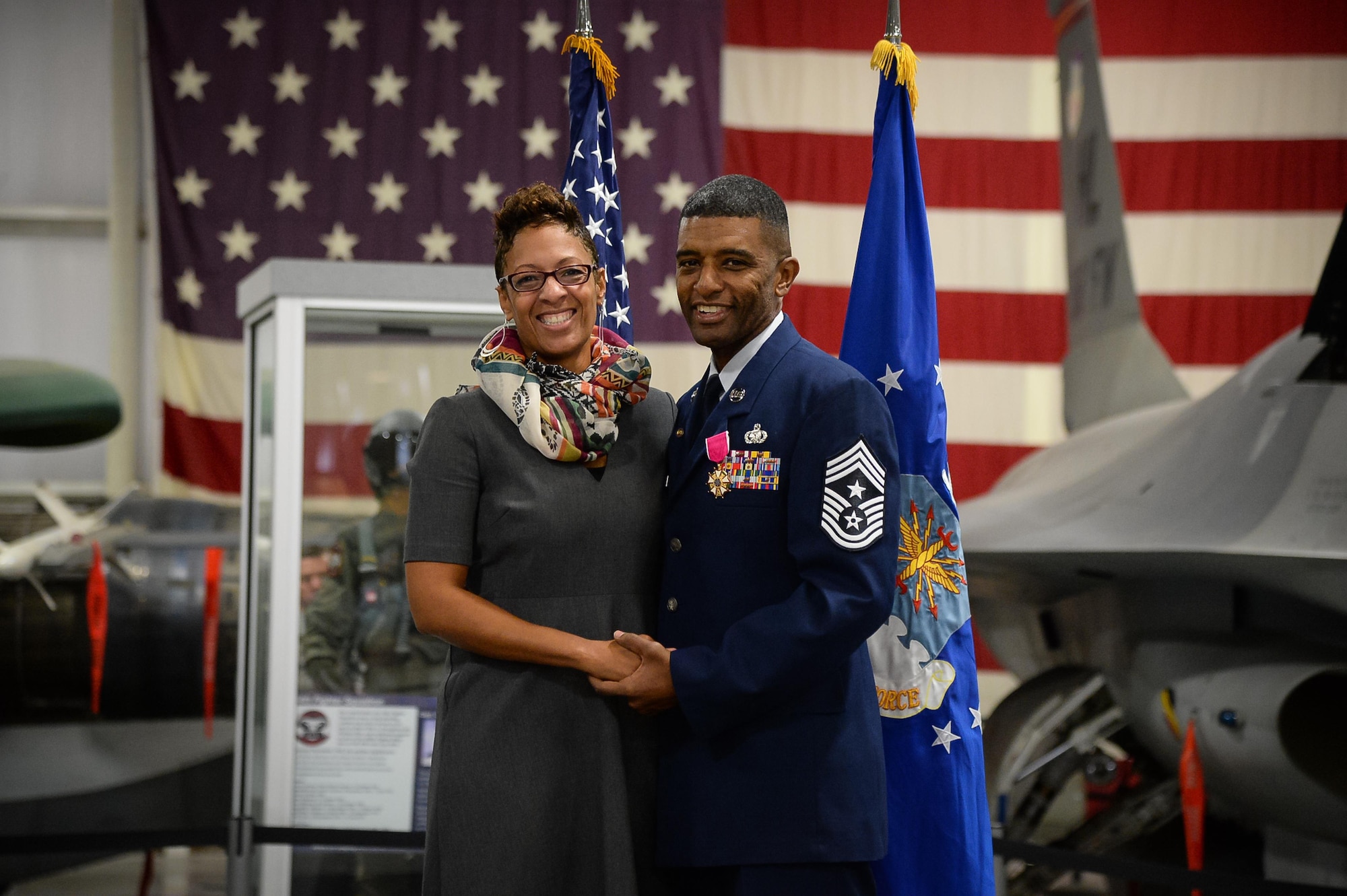 Chief Master Sgt. Rodney Gaither, 75th Air Base Wing command chief master sergeant, and his spouse, Lee, participate in his retirement ceremony Sept. 30 at the Hill Aerospace Museum. Gaither joined the Air Force in 1988 and served at numerous bases in the United States and overseas. (U.S. Air Force photo by R. Nial Bradshaw)