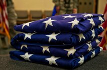 A set of U.S. flags rests on a stage at Minot Air Force Base, N.D., Sept. 27, 2016. Honor Guard Airmen hand-off folded flags to the next-of-kin during funerals and to the retiree during retirement ceremonies. (U.S. Air Force photo/Airman 1st Class Jonathan McElderry)