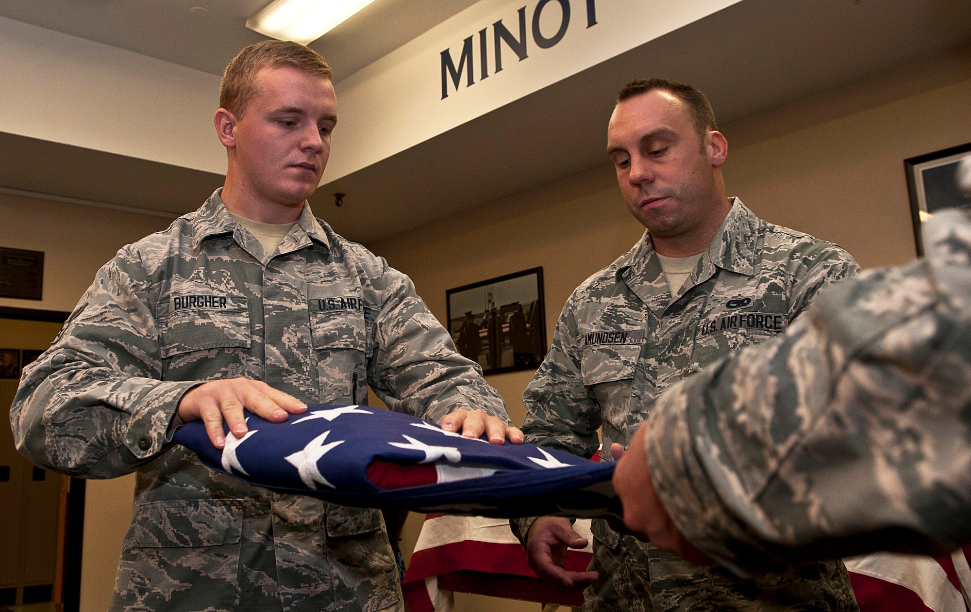 Airmen with the Minot Air Force Base Honor Guard practice flag-folding at Minot Air Force Base, N.D., Sept. 27, 2016. Flag-folding is one of the various parts of the Minot AFB Honor Guard’s two-week training course, which requires both patience and precision. (U.S. Air Force photo/Airman 1st Class Jonathan McElderry) 