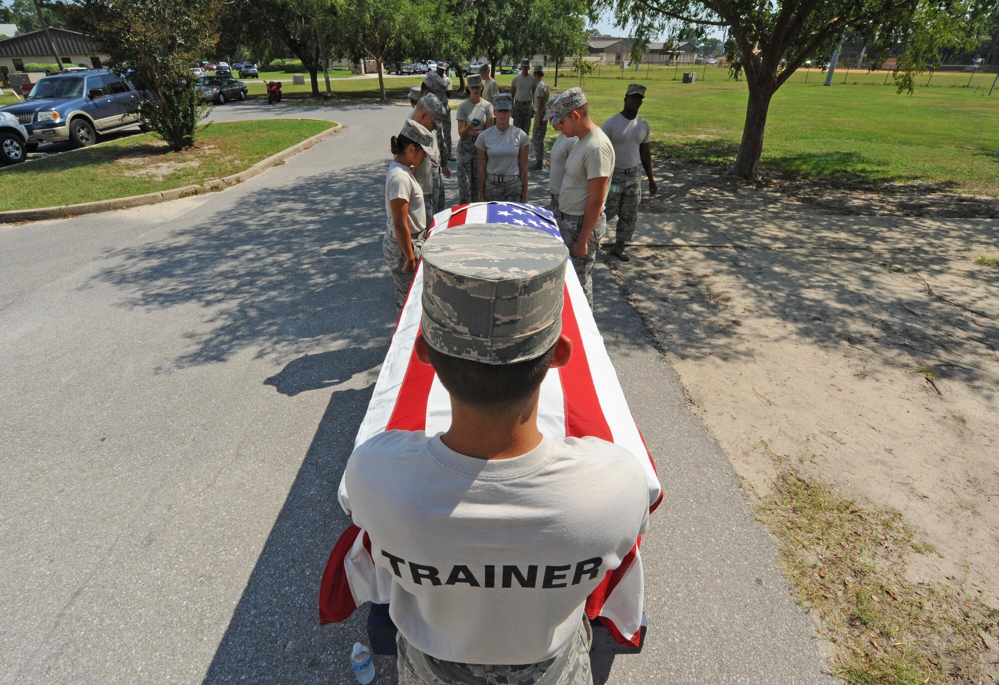 An honor guard trainer with the 1st Special Operations Force Support Squadron supervises trainees as they practice rendering honors for a funeral at Hurlburt Field, Fla., Sept. 28, 2016. While the initial training course is two weeks, an Airman must train for approximately two months before being considered qualified to participate in official ceremonies. (U.S. Air Force photo by Senior Airman Andrea Posey)
