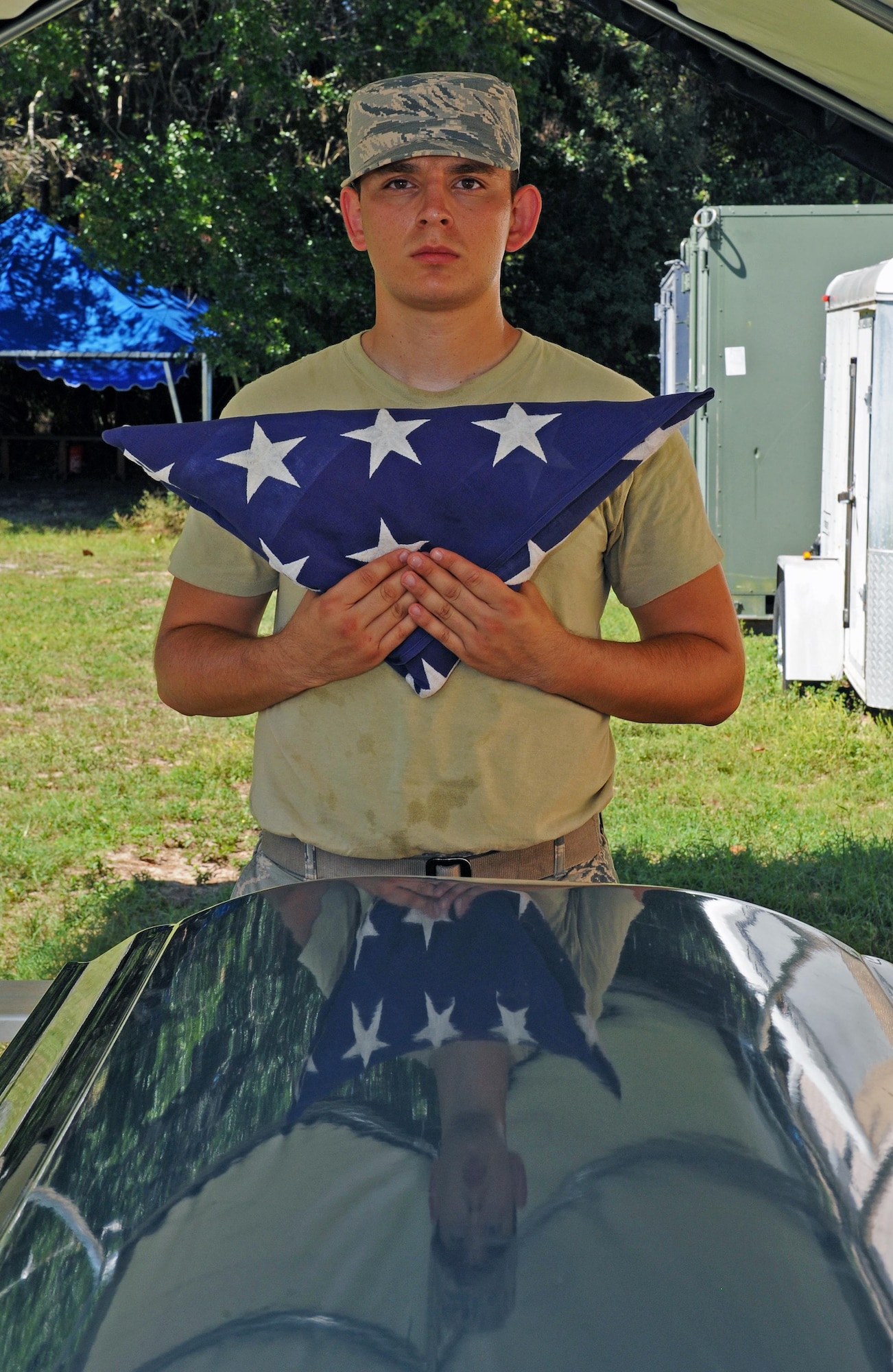 Senior Airman Manuel Lalane Tristan, an honor guard trainee with the 1st Special Operations Force Support Squadron, holds a folded flag after practicing a funeral ceremony at Hurlburt Field, Fla., Sept. 29, 2016. In an official ceremony, the flag would be presented to the next-of-kin as a sign of respect. (U.S. Air Force photo by Senior Airman Andrea Posey)