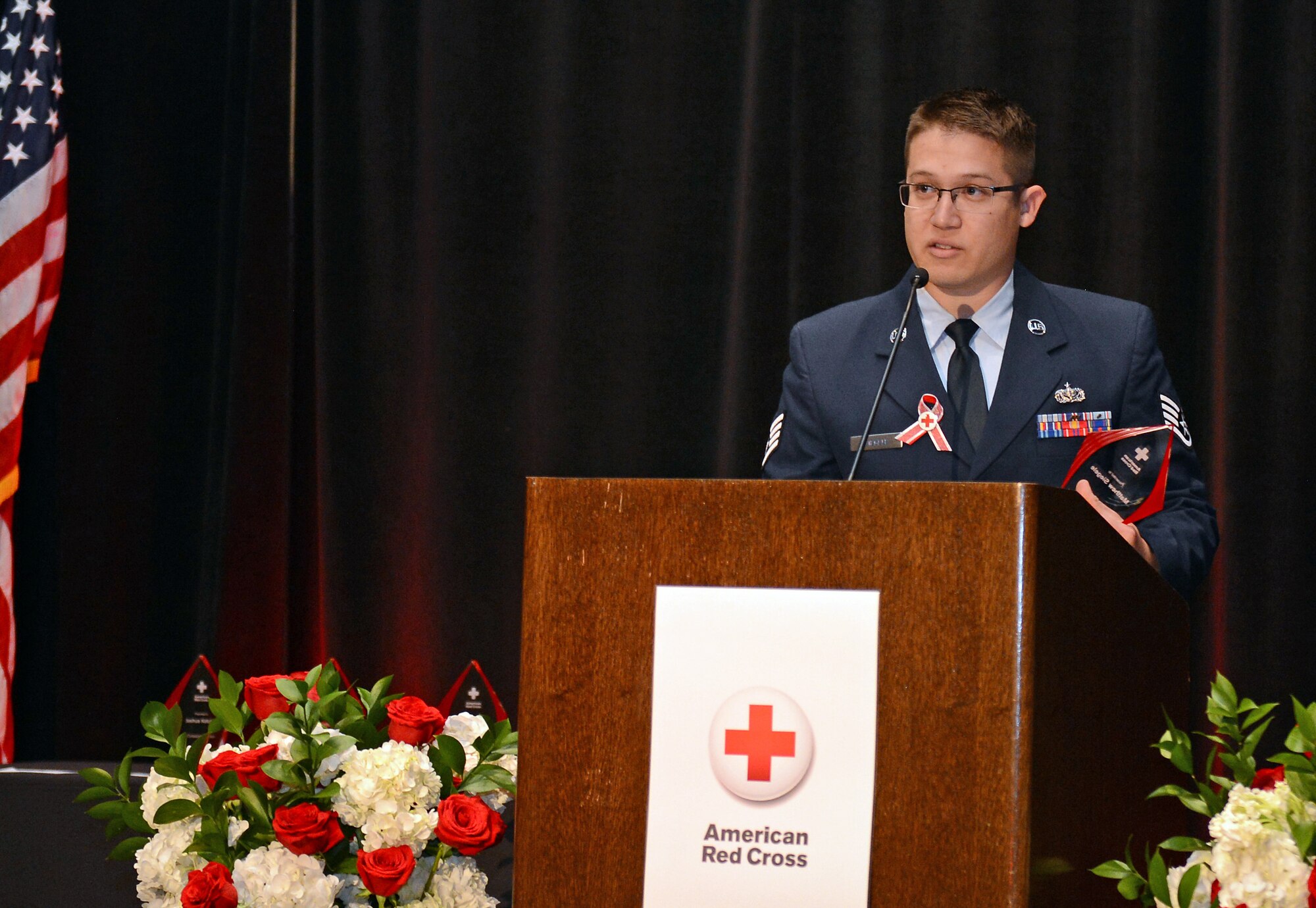 Staff Sgt. Matthew Siegele, 627th Force Support Squadron sports and fitness NCO in charge, gives a speech during the American Red Cross 2016 Heroes luncheon Sept. 28, 2016 in Tacoma, Wash. Siegele was the first of six individuals to be recognized at the annual Heroes event. (U.S. Air Force photo/Senior Airman Divine Cox)