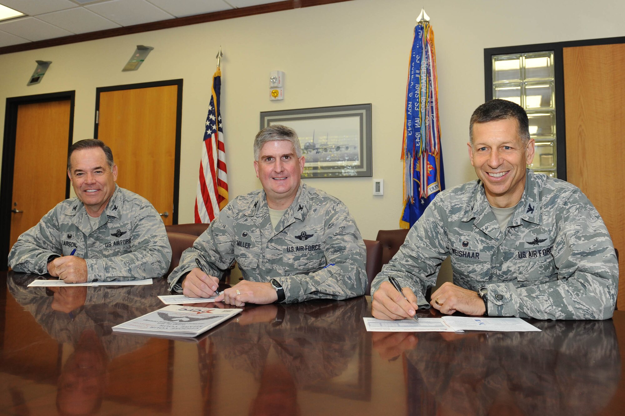 Col. Mark Larson, 931st Air Refueling Wing commander, left, Col. Albert Miller, 22nd ARW commander, and Col. David Weishaar, 184th Intelligence Wing commander, pose for a photo while they fill out their donation forms for the Combined Federal Campaign, Sept. 26, 2016, at McConnell Air Force Base, Kan. The CFC works on behalf of over 2,000 charitable organizations to raise money for health and human welfare causes. (U.S. Air Force photo/Ashley M. Wright)