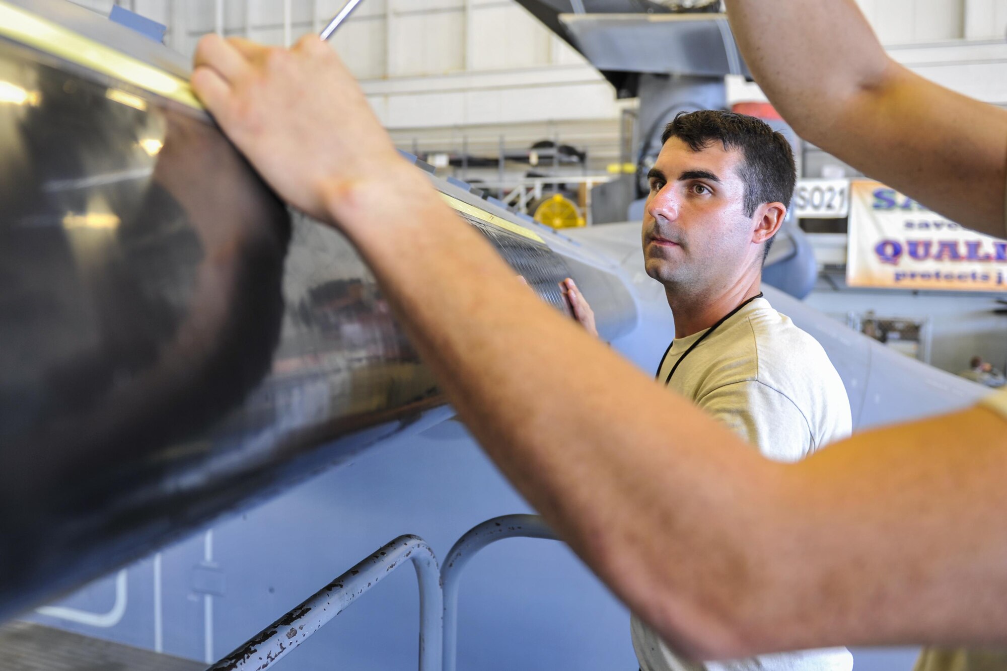 Staff Sgt. Dane Devlin, a crew chief with the 801st Special Operations Aircraft Maintenance Squadron, holds a de-ice boot onto a CV-22 Osprey while another crew chief screws it in at Hurlburt Field, Fla., Sept. 29, 2016. A de-icing boot is an ice protection system installed on aircraft surfaces to perform mechanical de-icing on aircraft in flight. (U.S. Air Force photo by Airman 1st Class Joseph Pick)
