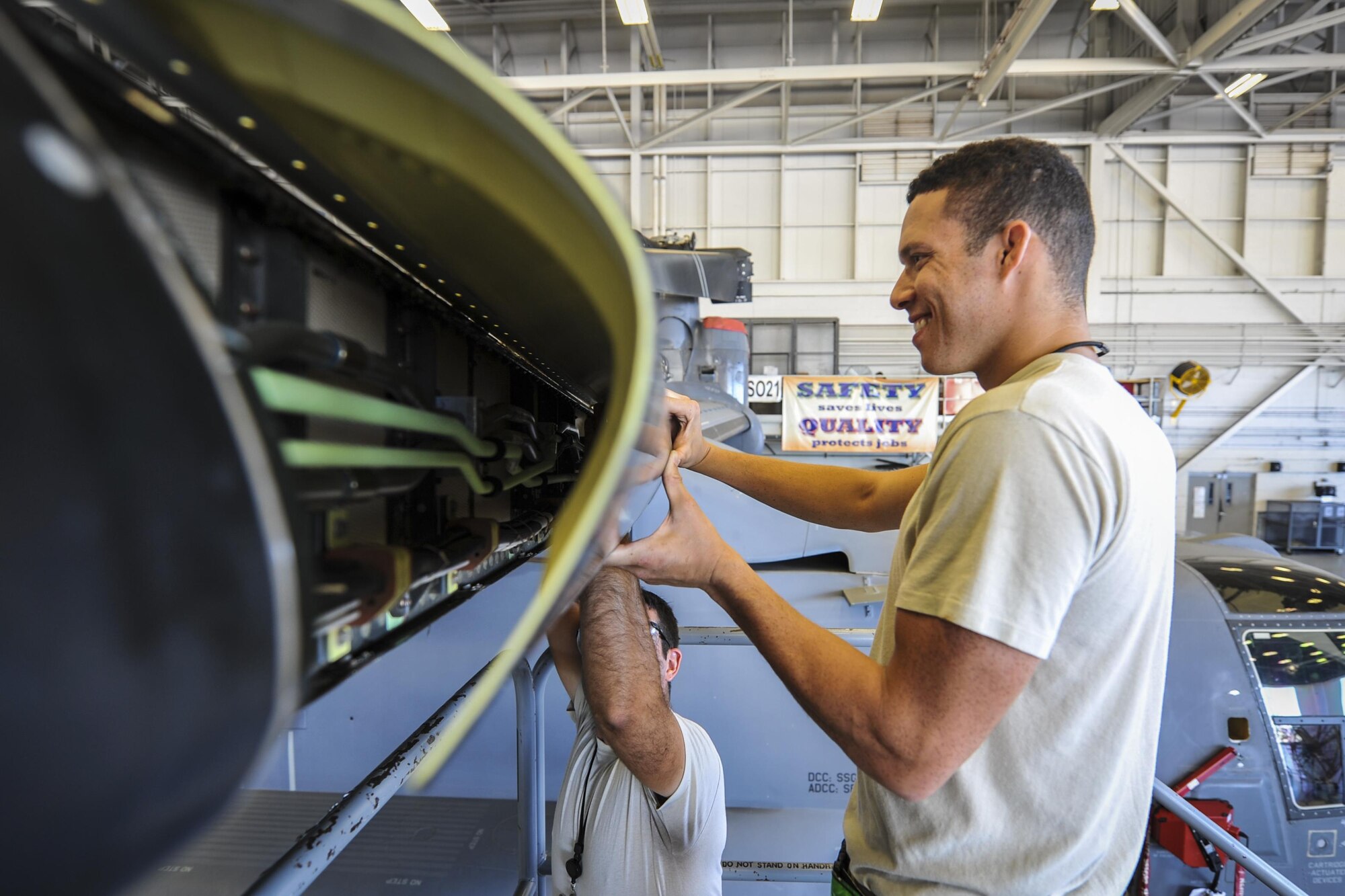 Staff Sgt. Marcus Clement, right, a crew chief with the 801st Special Operations Aircraft Maintenance Squadron, holds the de-ice boot for a CV-22 Osprey tiltrotor aircraft while Staff Sgt. Dane Devlin, a crew chief with the 801st SOAMXS, removes it at Hurlburt Field, Fla., Sept. 29, 2016. A de-icing boot is an ice protection system installed on aircraft surfaces to perform mechanical de-icing on aircraft in flight. (U.S. Air Force photo by Airman 1st Class Joseph Pick)