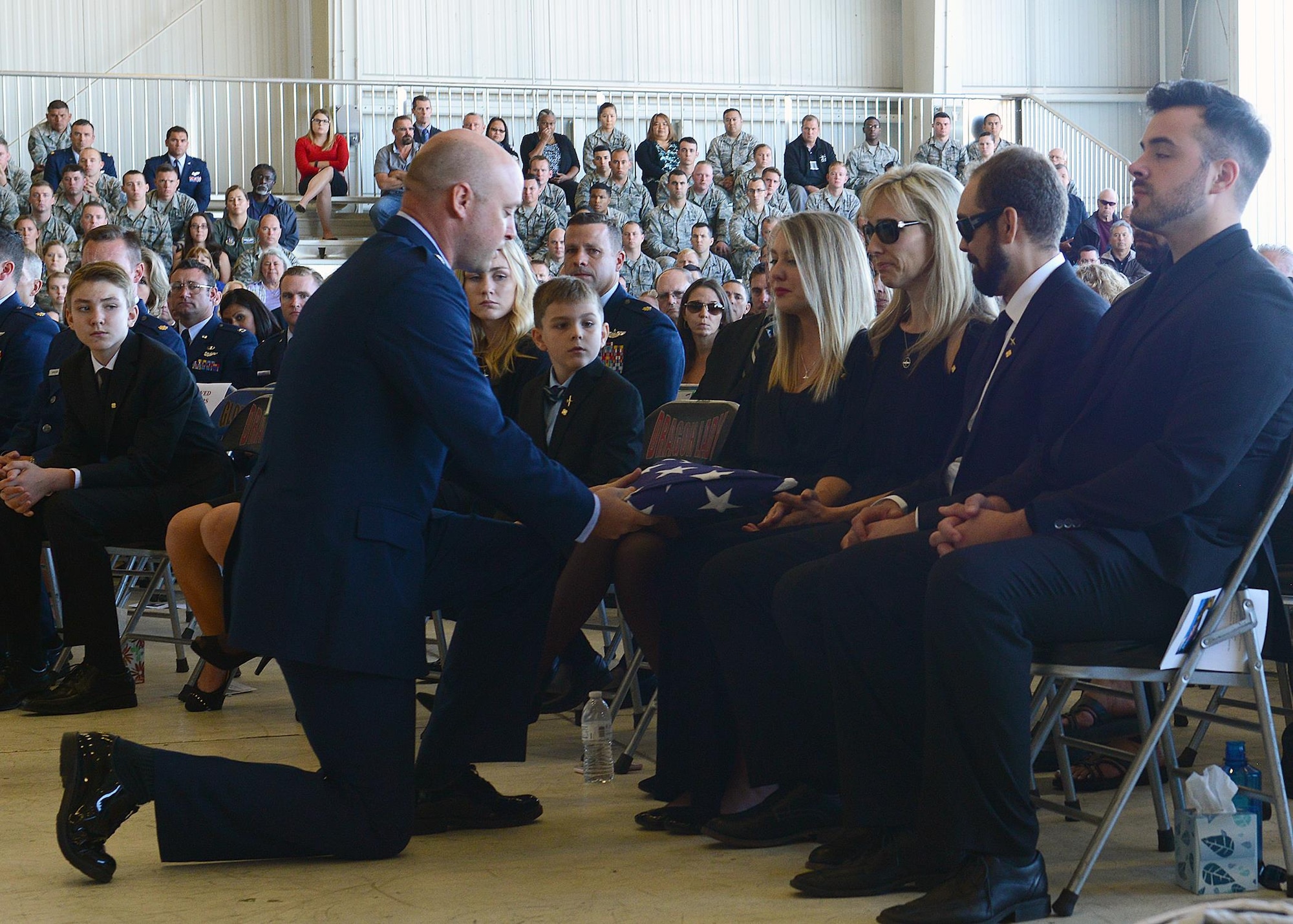 Lt. Col. Paul Wurster, 1st Reconnaissance Squadron commander, presents a flag to Mrs. Ashley Eadie, the wife of Lt. Col. Steve “Shooter” Eadie, during a memorial service at Beale Air Force Base, California, Sept. 29, 2016. Lt. Col. Eadie, was killed Sept. 20, 2016, when a U-2 Dragon Lady he was piloting crashed in the Sutter Buttes mountain range. Ashley and Lt. Col. Eadie were married for 27 years. (U.S. Air Force photo/Chandresh Bhakta)