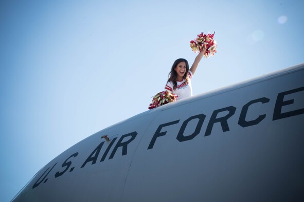 Katrina (team policy dictates that she doesn't share her last name), National Football League cheerleader from the Kansas City Chiefs, waves from the top of a C-130J Super Hercules. She and three of her teammates visited Keesler Air Force Base as art of an event hosted by the Army and Air Force Exchange Service that included a tour of the base, a Chiefs’ Cheerleader clinic for children at the Youth Center and a fashion show at the main Exchange. (U.S. Air Force photo/Senior Airman Heather Heiney) 