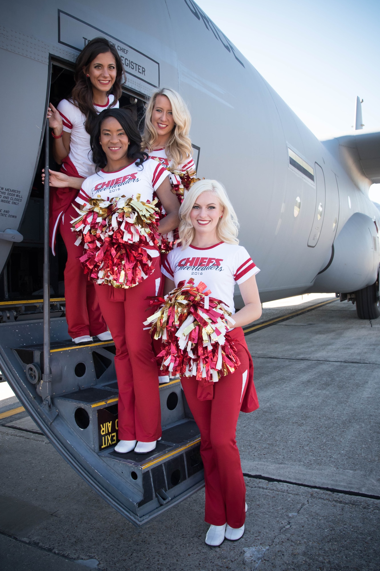 Katrina, Tara, Sarah and Claire (team policy dictates that they don't share their last names), National Football League cheerleaders from the Kansas City Chiefs, pose for a photo on the steps of a C-130J Super Hercules aircraft. The cheerleaders visited Keesler Air Force Base as part of an event hosted by the Army and Air Force Exchange Service that included a tour of the base, a Chiefs’ Cheerleader clinic for children at the Youth Center and a fashion show at the main Exchange. (U.S. Air Force photo/Senior Airman Heather Heiney) 