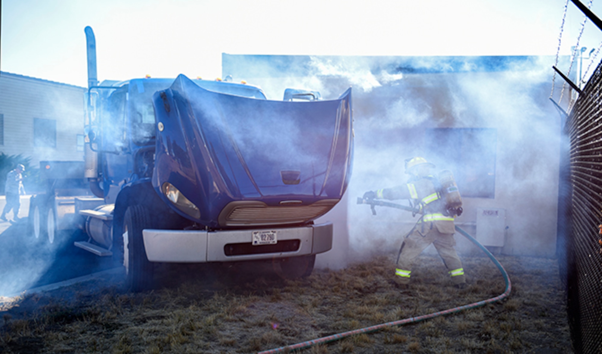 A Team Fairchild firefighter simulates handling a vehicle incident during an Emergency Management Exercise Sept. 27, 2016, at Fairchild Air Force Base, Wash. Exercises allow members of the base to see where improvements should be made and build on base capabilities. Continuing to do these exercises ensures the base is prepared to handle any real world situations that may happen. (U.S. Air Force photo/Airman 1st Class Sean Campbell)