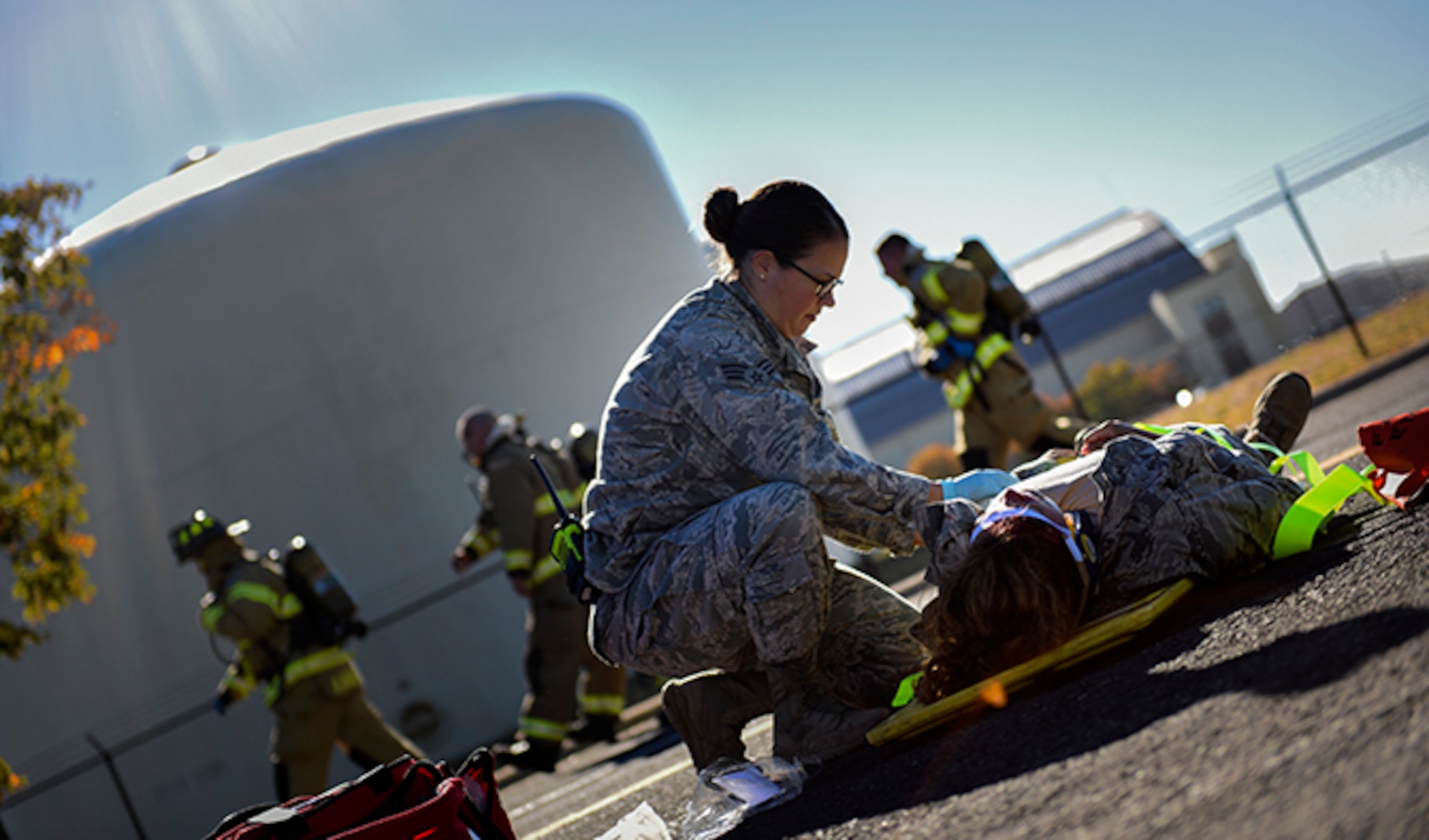 Senior Airman Julie Fink, 92nd Medical Operations Squadron aerospace medical technician, provides medical care to a simulated victim of a vehicle incident during an Emergency Management Exercise Sept. 27, 2016, at Fairchild Air Force Base, Wash. The 92nd Air Refueling Wing and 141st ARW Inspector Generals, 18 subject matter experts from various parts of the base, 30 Wing Inspection Team members and 14 actors from the 92nd ARW and 141st ARW participated in the exercise. (U.S. Air Force photo/Airman 1st Class Sean Campbell)