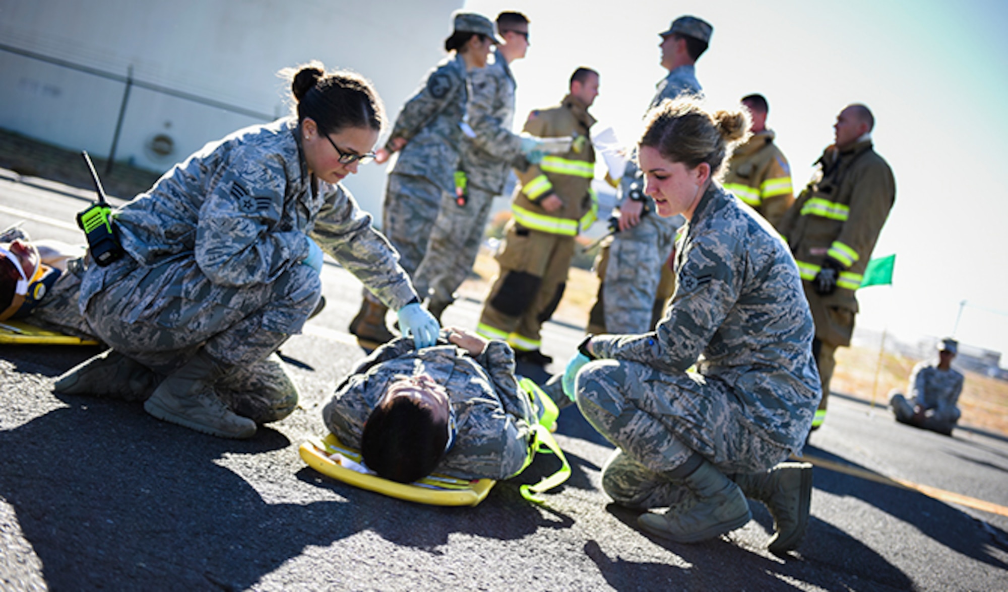 Senior Airman Julie Fink, 92nd Medical Operations Squadron aerospace medical technician, and Airman 1st Class Shawn McMahan, 92nd Medical Operations Squadron emergency medical technician, provides medical care to a simulated victim of a vehicle incident during an Emergency Management Exercise Sept. 27, 2016, at Fairchild Air Force Base, Wash. The base participates in different types of scenarios and situations, to be prepared when an incident occurs. (U.S. Air Force photo/Airman 1st Class Sean Campbell) 