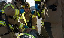 Team Fairchild firefighters secure a simulated victim for transport during an Emergency Management Exercise Sept. 29, 2016, at Fairchild Air Force Base, Wash. Fairchild firefighters work in tandem with the 92nd Medical Squadron’s ambulance services emergency medical technicians to provide the base with rapid first response to emergencies. (U.S. Air Force photo/Airman 1st Class Ryan Lackey)
