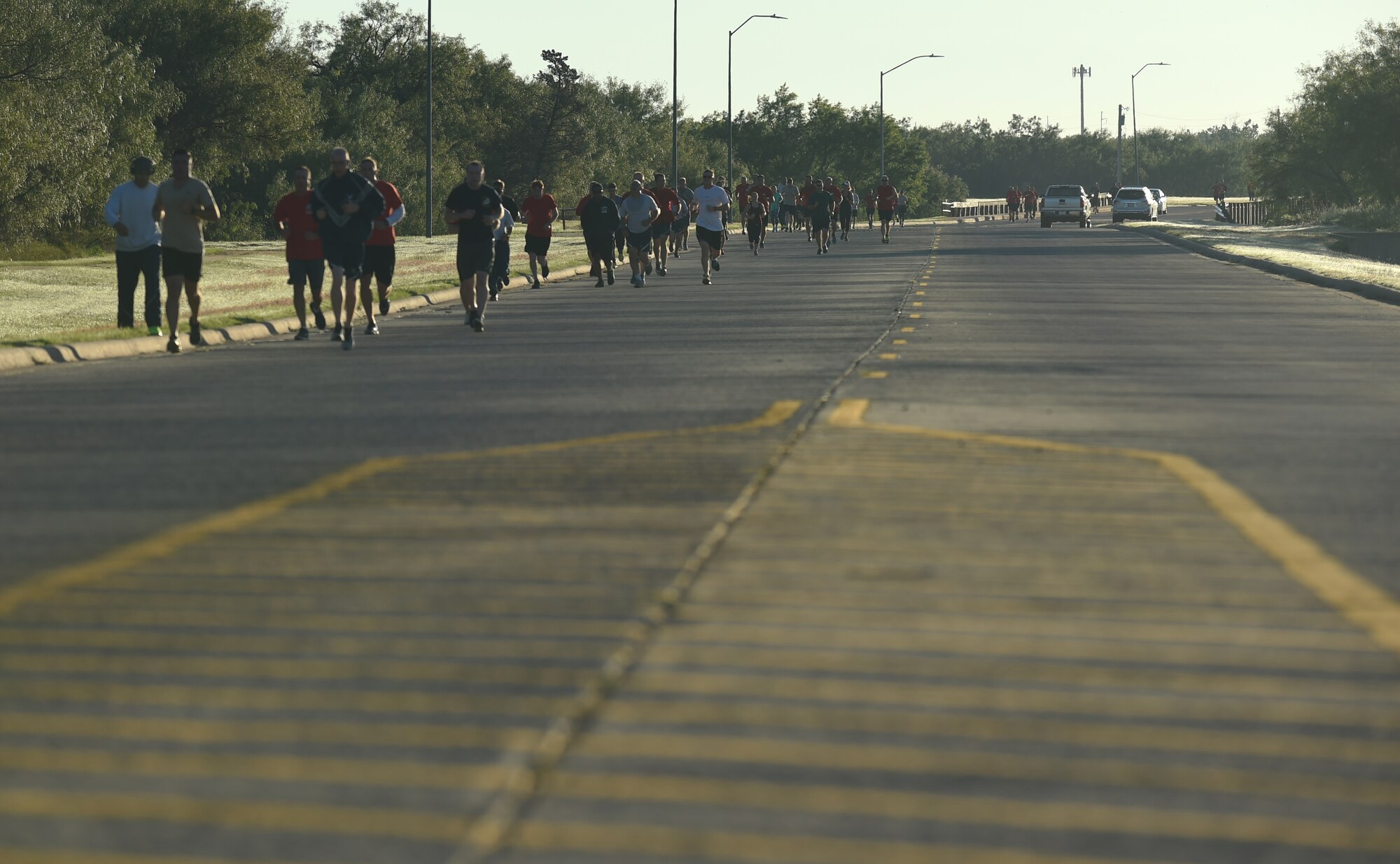 Airmen, families and members of the Abilene community run down a road at Dyess Air Force Base, Texas, Sept. 30, 2016. The 6.2 mile run was in honor of the members of TORQE 62 who were killed in a C-130J Super Hercules crash in Jalalabad, Afghanistan, Oct. 2, 2015. (U.S. Air Force photo by Airman 1st Class Quay Drawdy)