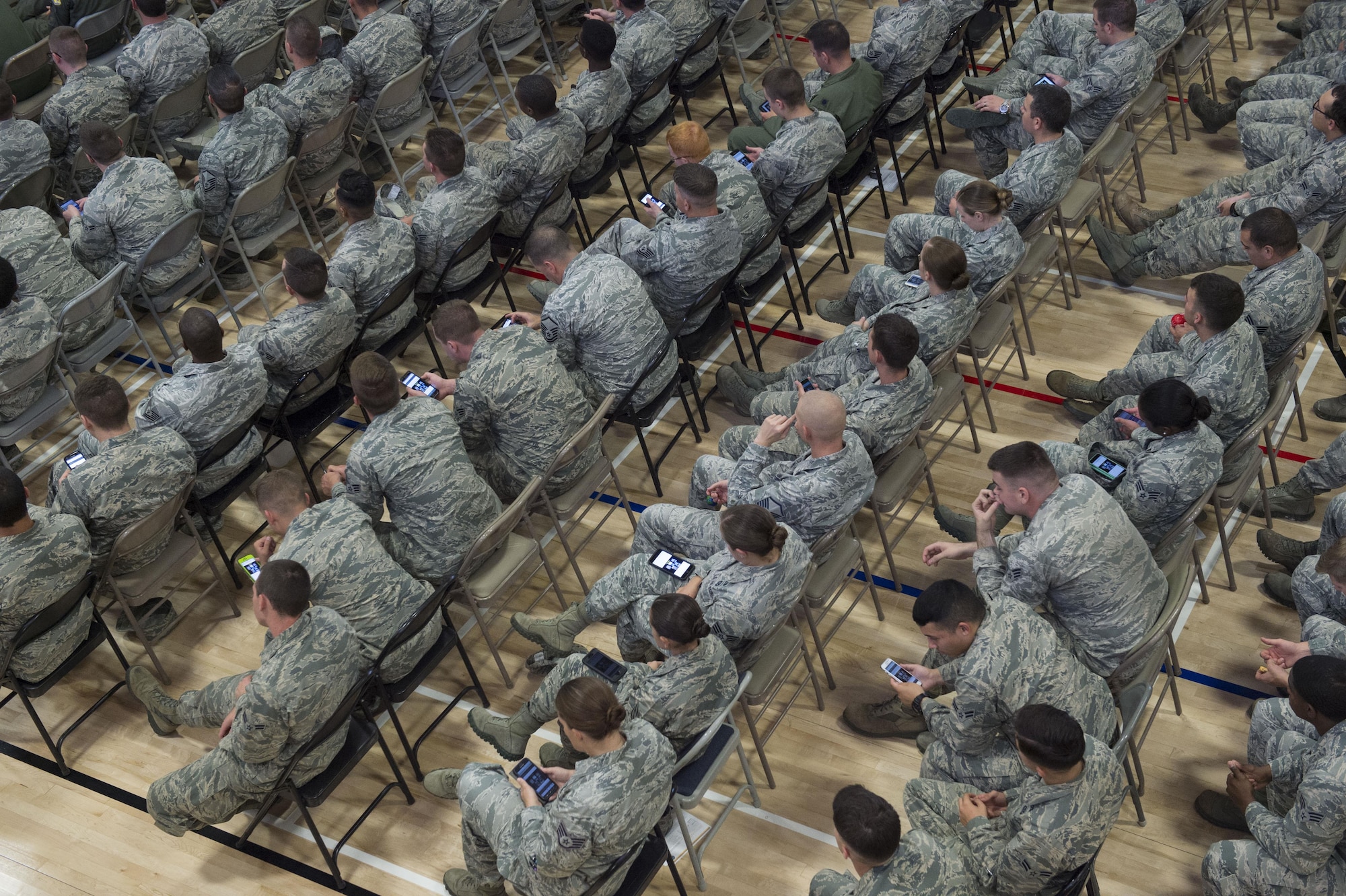 Holloman Airmen use their cell phones to take part in an interactive poll to answer questions posed by the commander. They could also ask the commander questions during his commander’s call at Holloman Air Force Base, N.M., on Sept. 29. Colonel Houston Cantwell, the 49th Wing commander, utilized this innovative technology to open a direct line of communication between himself and the Airmen of Holloman. This allowed each Airman to ask and answer questions. (U.S. Air Force photo by Senior Airman Aaron Montoya)