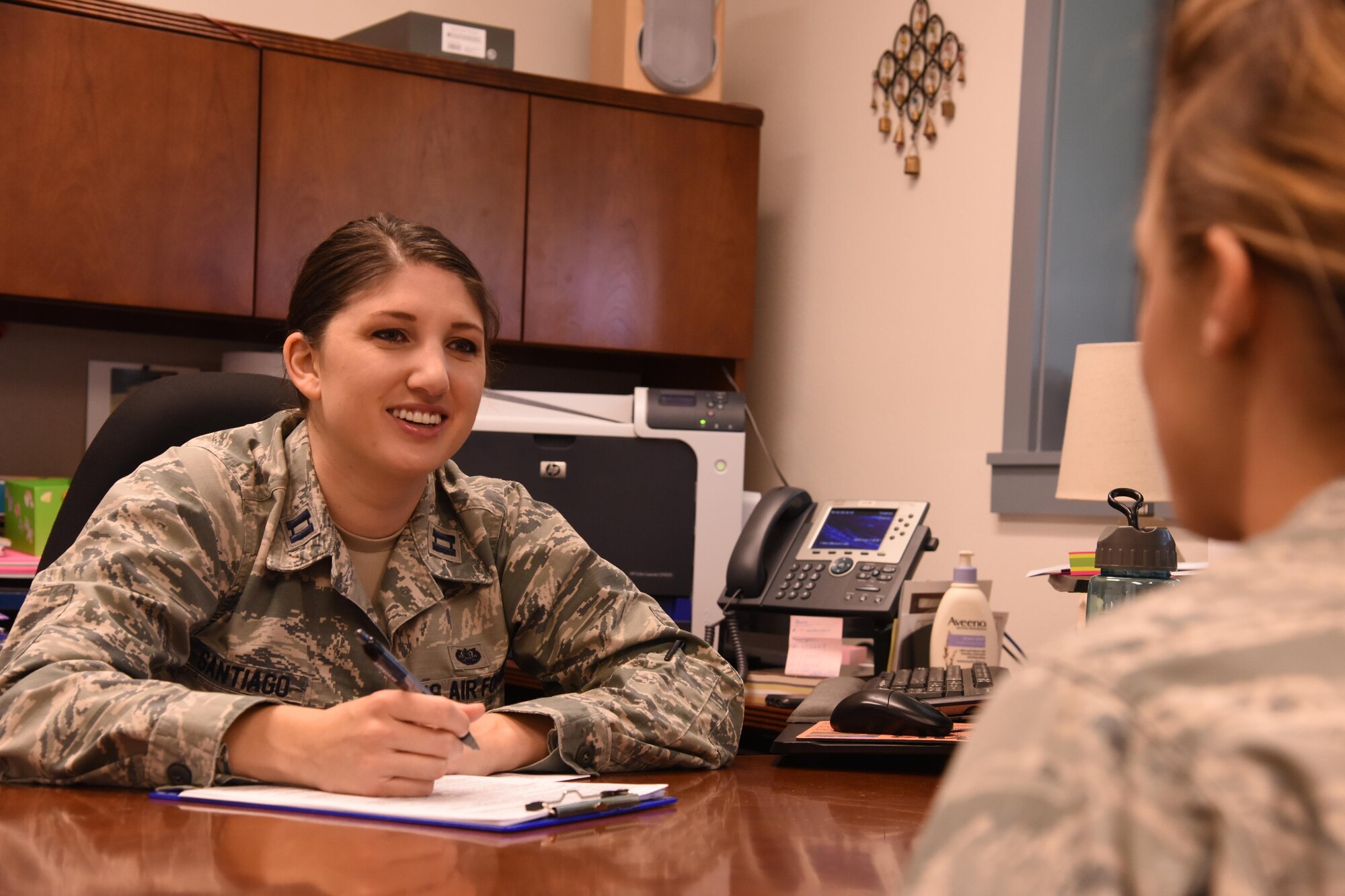 Capt. Catherine Santiago, Air Force Legal Operations Special Victims’ Counsel attorney, speaks with a client at the base legal office Sept. 30, 2016, at Malmstrom Air Force Base, Mont. Santiago is Malmstrom’s first SVC attorney, and helps victims of sexual assault through the military justice program. (U.S. Air Force photo/Senior Airman Jaeda Tookes)