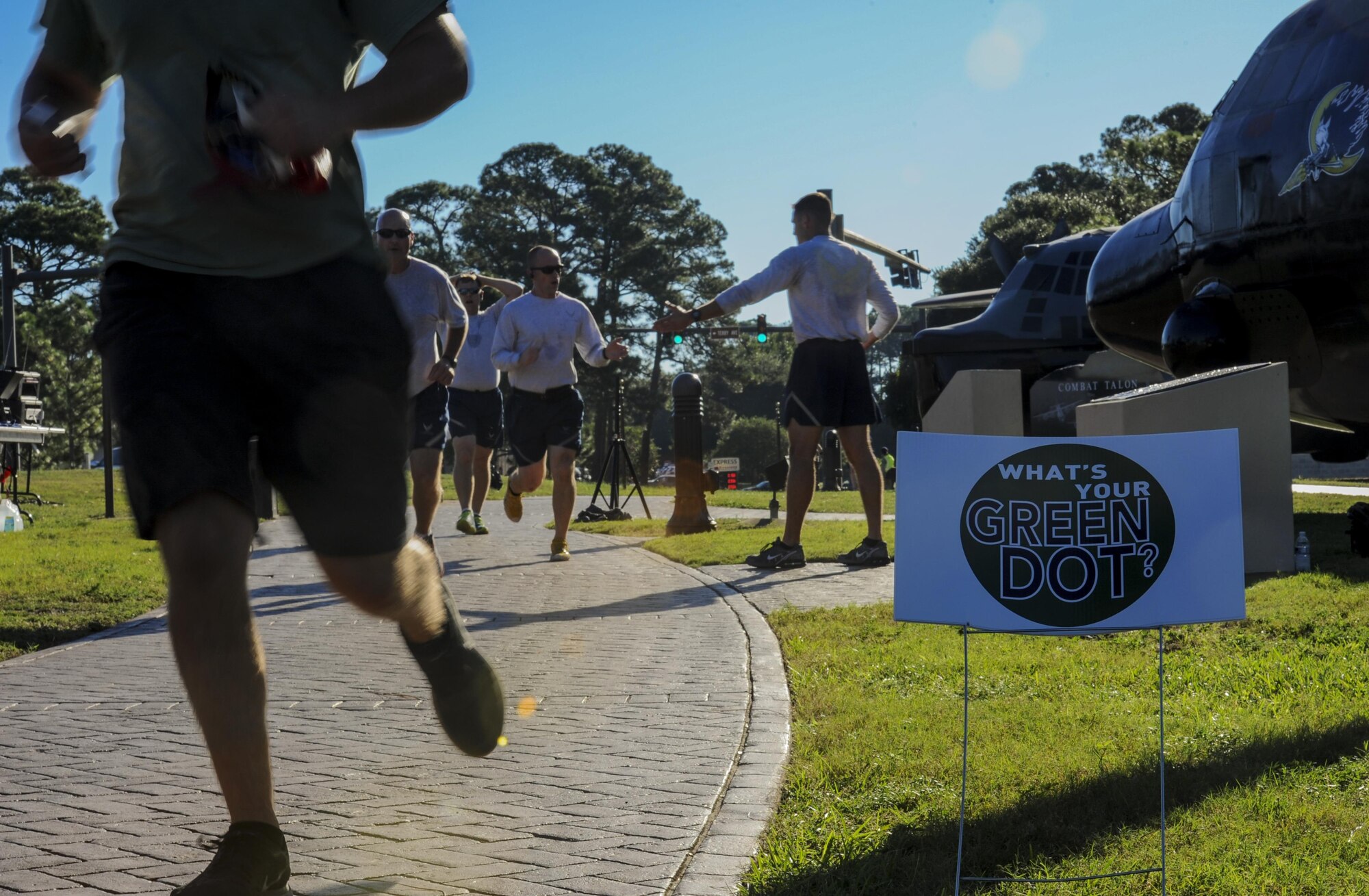 Air Commandos cross the finish line during the Green Dot 5k at Hurlburt Field, Fla., Sept. 30, 2016. Green Dot is an organization that plans to reduce power-based interpersonal violence, which includes sexual, domestic and dating violence. (U.S. Air Force photo by Airman 1st Class Isaac O. Guest IV)