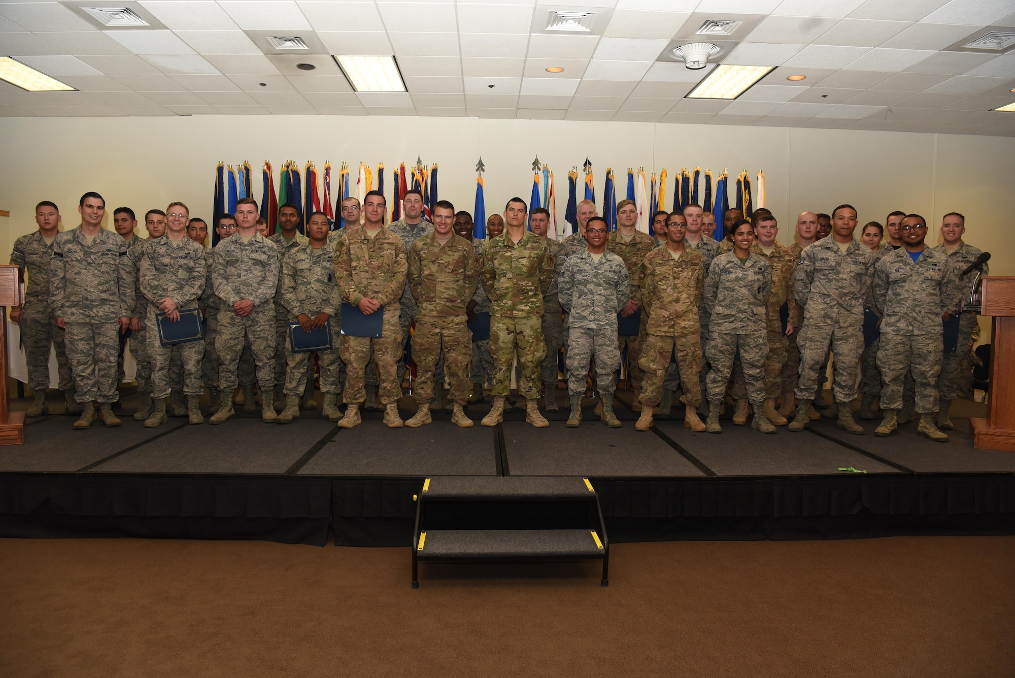 Enlisted Airmen who promoted in September, pose for a photo, Sept. 30, 2016, at F.E. Warren Air Force Base, Wyo. Each month the Mighty Ninety hosts a celebration for enlisted promotees from the base. (U.S. Air Force photo by Airman 1st Class Breanna Carter)