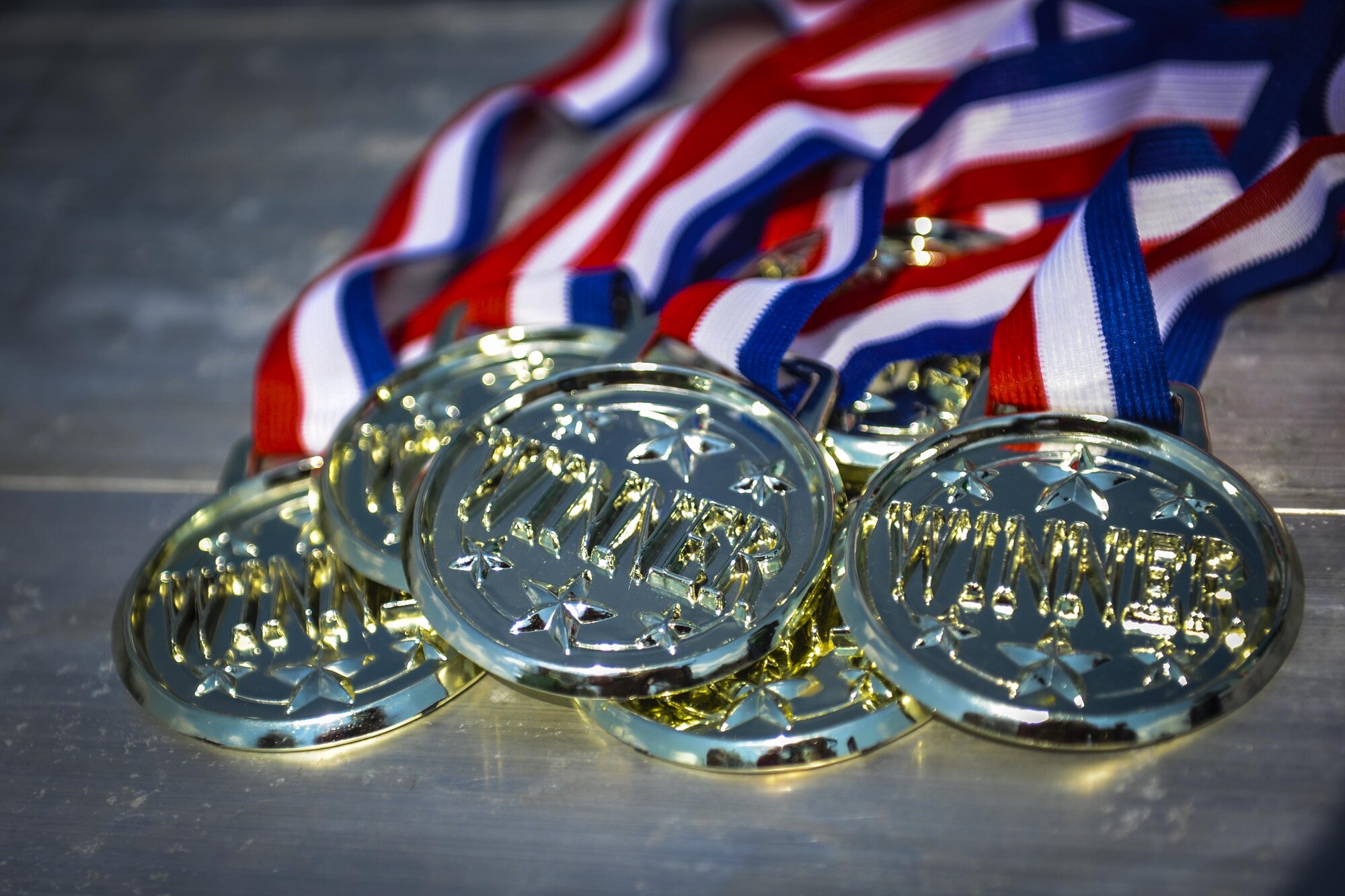 Medals sit on a table at the Green Dot Olympics on Hurlburt Field, Fla., Sept. 28, 2016. The winning team, the 1st Special Operations Logistics Readiness Squadron, won gold medals after defeating other competitors during the event. (U.S. Air Force photo by Airman Dennis Spain)
