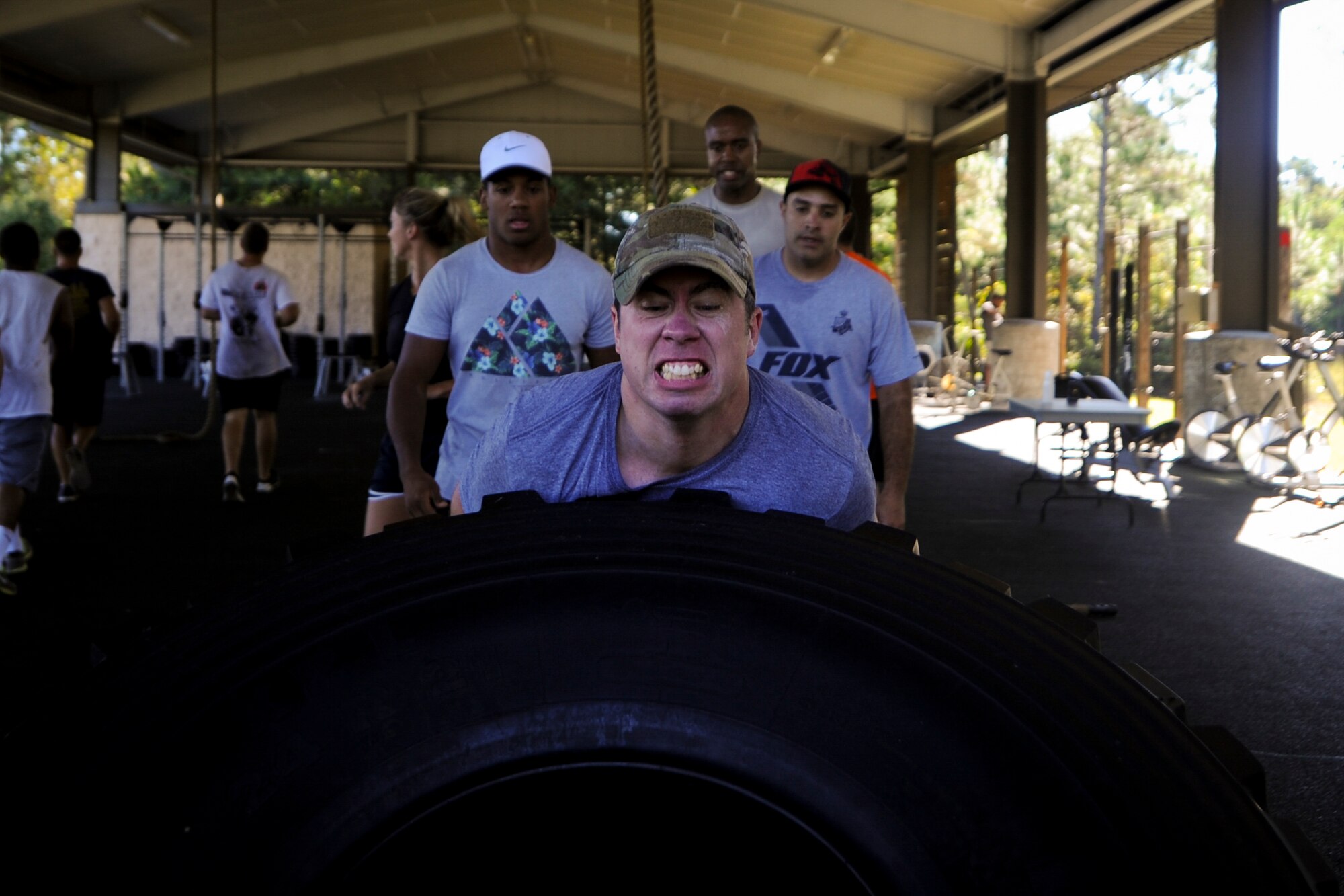 Senior Airman Benjamin Rhoades, a vehicle operator with the 1st Special Operations Logistics Readiness Squadron, flips a tire during the Air Force Special Operations Command Team Cohesion Challenge at Hurlburt Field, Fla., Sept. 29, 2016. Rhoades and other participants performed a variety of tasks including pushing a Humvee, rucking and performing low-crawls in sand. (U.S. Air Force photo by Airman Dennis Spain)
