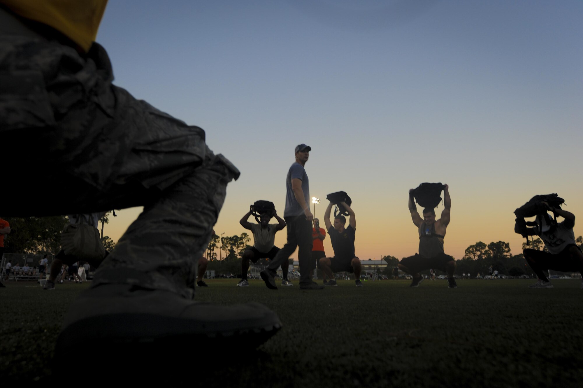 Air Commandos squat while holding their ruck sacks above their head during the Air Force Special Operations Command Team Cohesion Challenge at Hurlburt Field, Fla., Sept. 29, 2016. The event is designed to challenge individuals to work as a team to endure difficult circumstances. (U.S. Air Force photo by Airman Dennis Spain)
