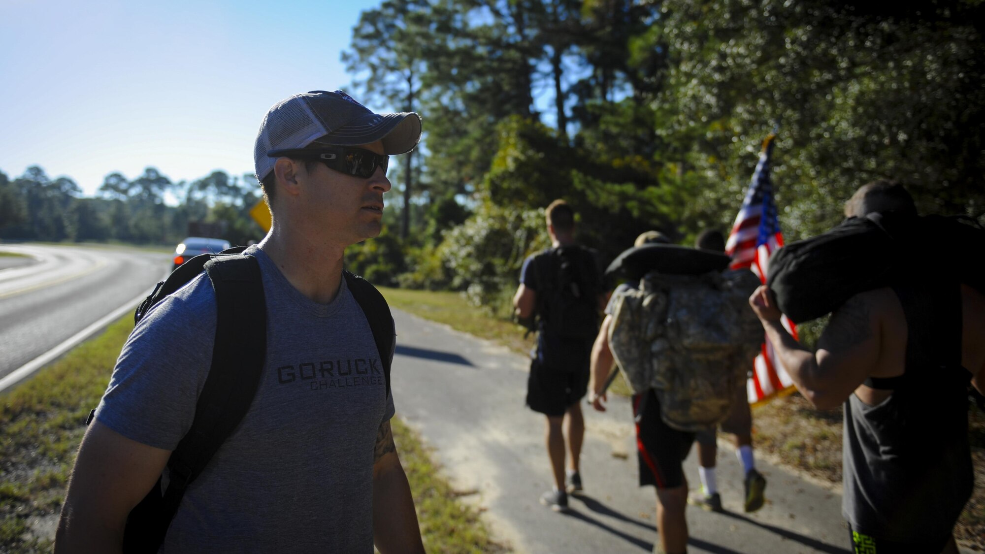 Kevin Randolph, the cadre of the Air Force Special Operation Command Team Cohesion Challenge, guides the formation as they march to the next exercise at Hurlburt Field, Fla., Sept. 29, 2016. Randolph travels to various locations leading team cohesion challenges to teach people to work as a team through difficult circumstances. (U.S. Air Force photo by Airman Dennis Spain) 
