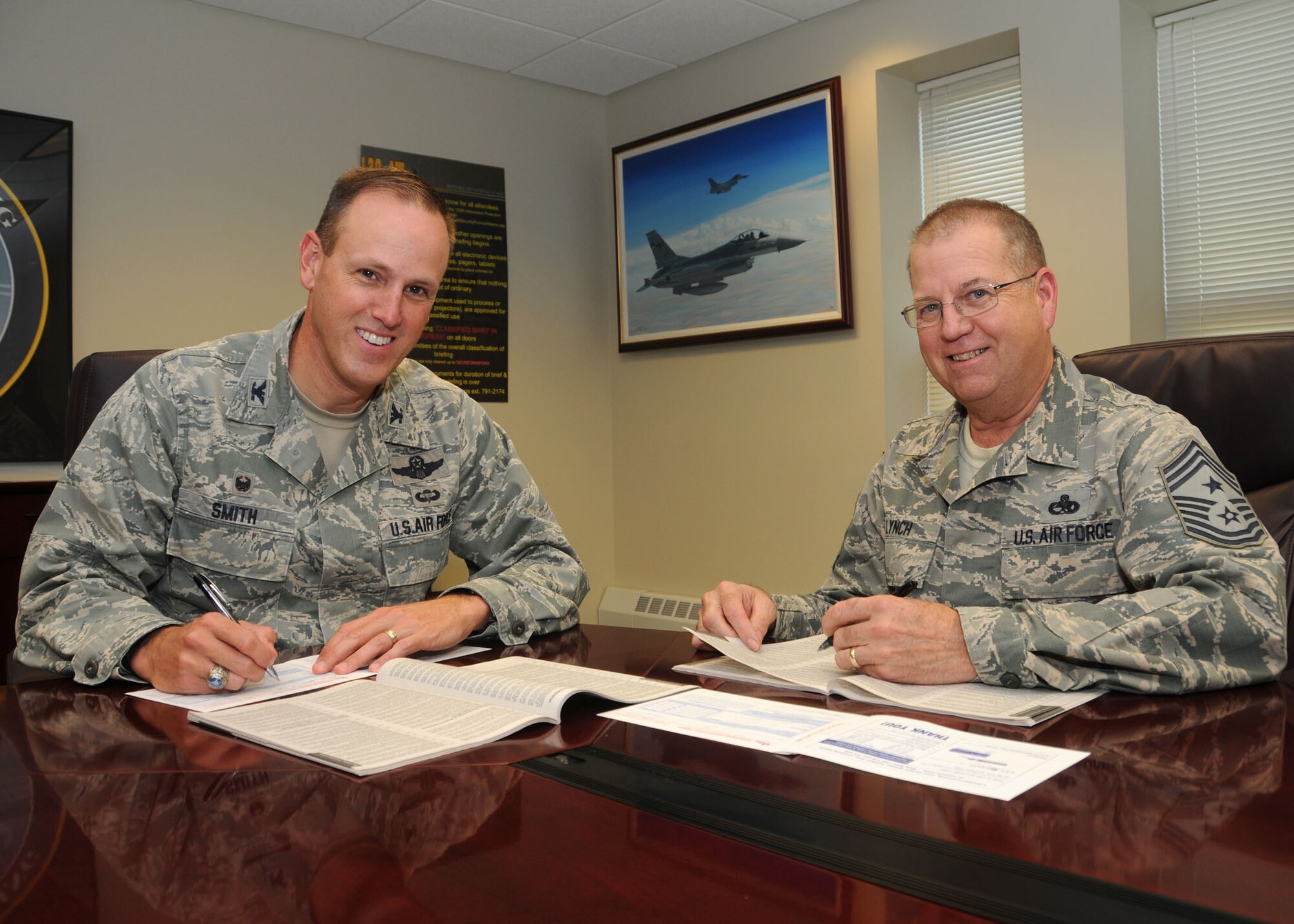 120th Airlift Wing Commander Col. Lee Smith and 120th AW Command Chief Master Sgt.  Steven Lynch review their Combined Federal Campaign booklets Sept. 29, 2016. The federally-approved campaign to raise funds for charities runs from October 1 through December 15, 2016 for the 120th AW in Great Falls, Mont. (U.S. Air National Guard photo by Senior Master Sgt. Eric Peterson)