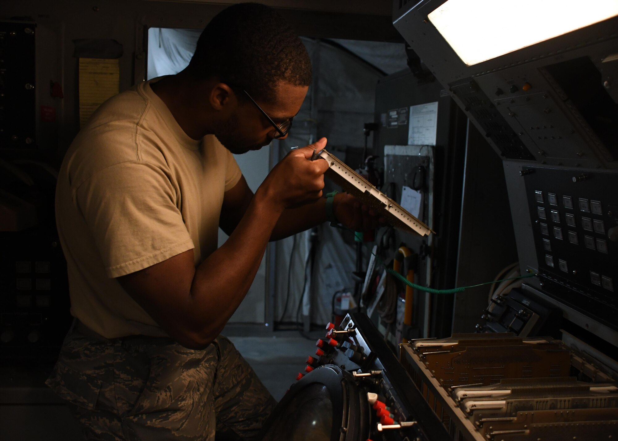 U.S. Air Force Senior Airman Darrin Brewer, a ground radar systems technician with the 727th Expeditionary Air Control Squadron Detachment 3, cleans out a plan position indicator on a radar system at Al Udeid Air Base, Qatar, March 31, 2017. Brewer deployed with 32 other Airmen from the 726th ACS at Mountain Home Air Force Base, Idaho, and works to maintain ground radar systems at Al Udeid. (U.S. Air Force photo by Senior Airman Miles Wilson)