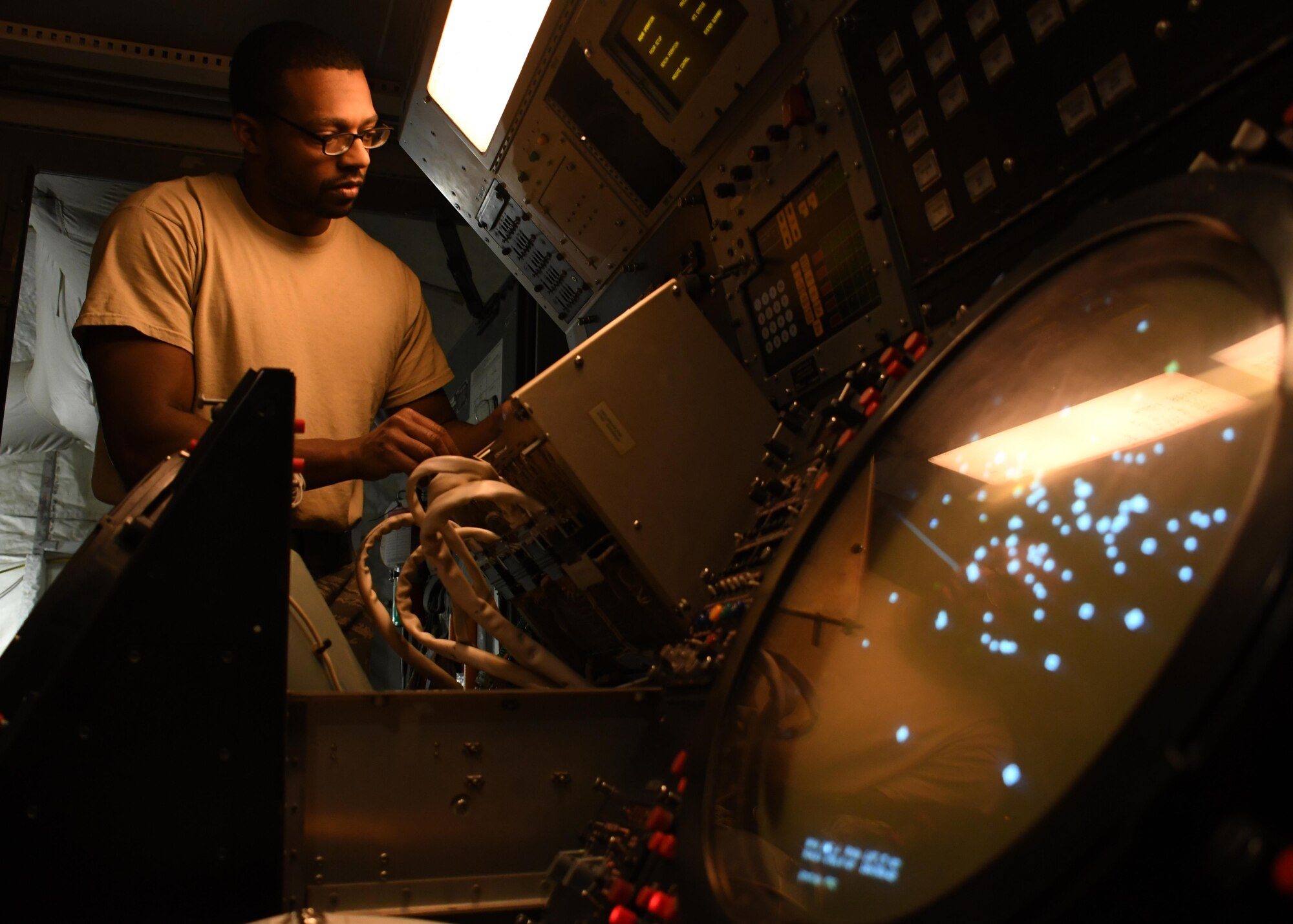 U.S. Air Force Senior Airman Darrin Brewer, a ground radar systems technician with the 727th Expeditionary Air Control Squadron Detachment 3, checks the plan position indicators inside of a radar system at Al Udeid Air Base, Qatar, March 31, 2017. The 727th EACS Det. 3 works to maintain two ground radar systems at Al Udeid, and ensures that at least one of them is running at all times. (U.S. Air Force photo by Senior Airman Miles Wilson)